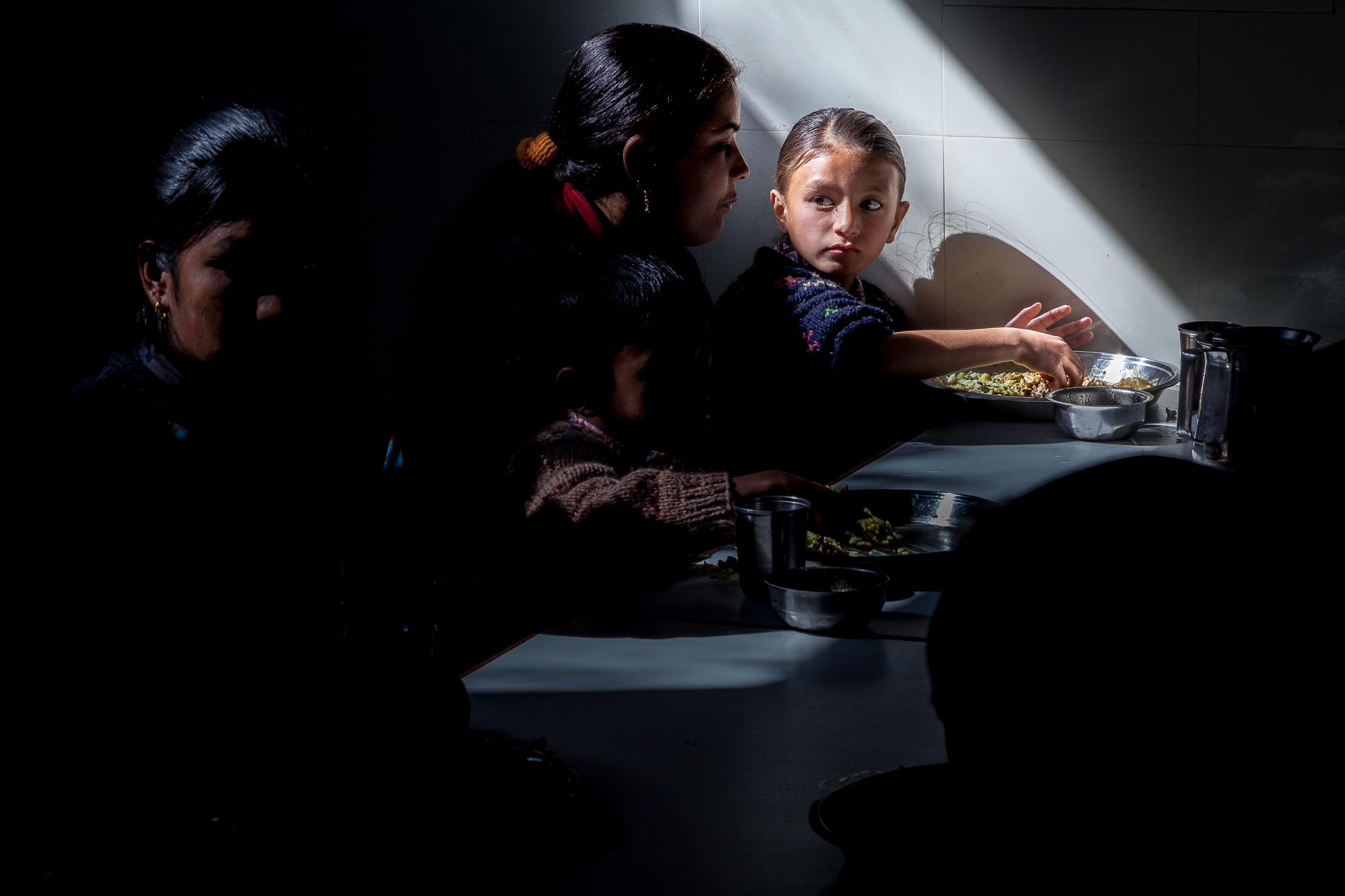 SUNAKOTHI, NEPAL - JANUARY 28: A group of mothers and children have lunch inside the dining hall of the Nepal Youth Foundation&rsquo;s...