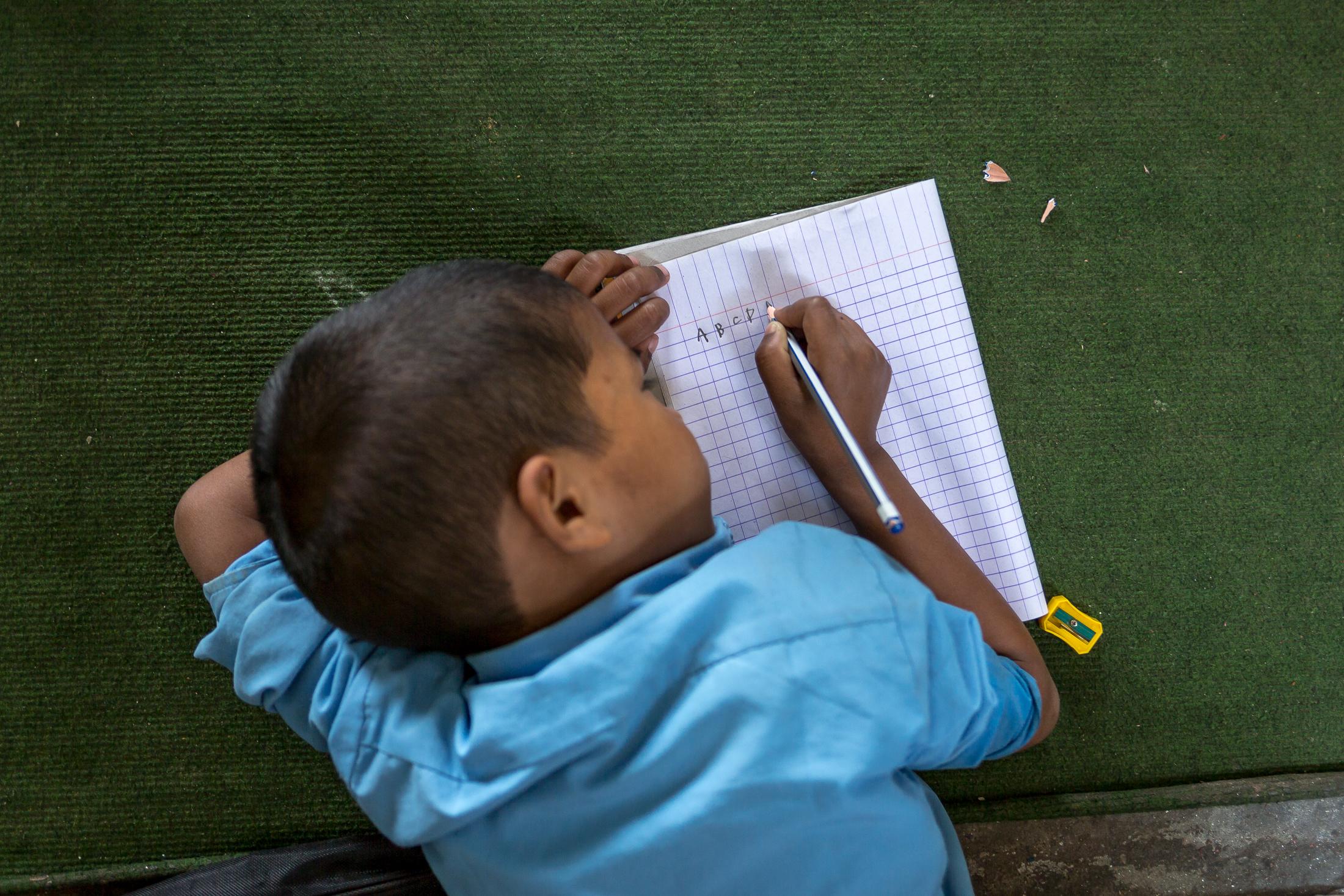 Portfolio NGO Education  - SIDDHIPUR, NEPAL - MAY 08: A young boy writes the...