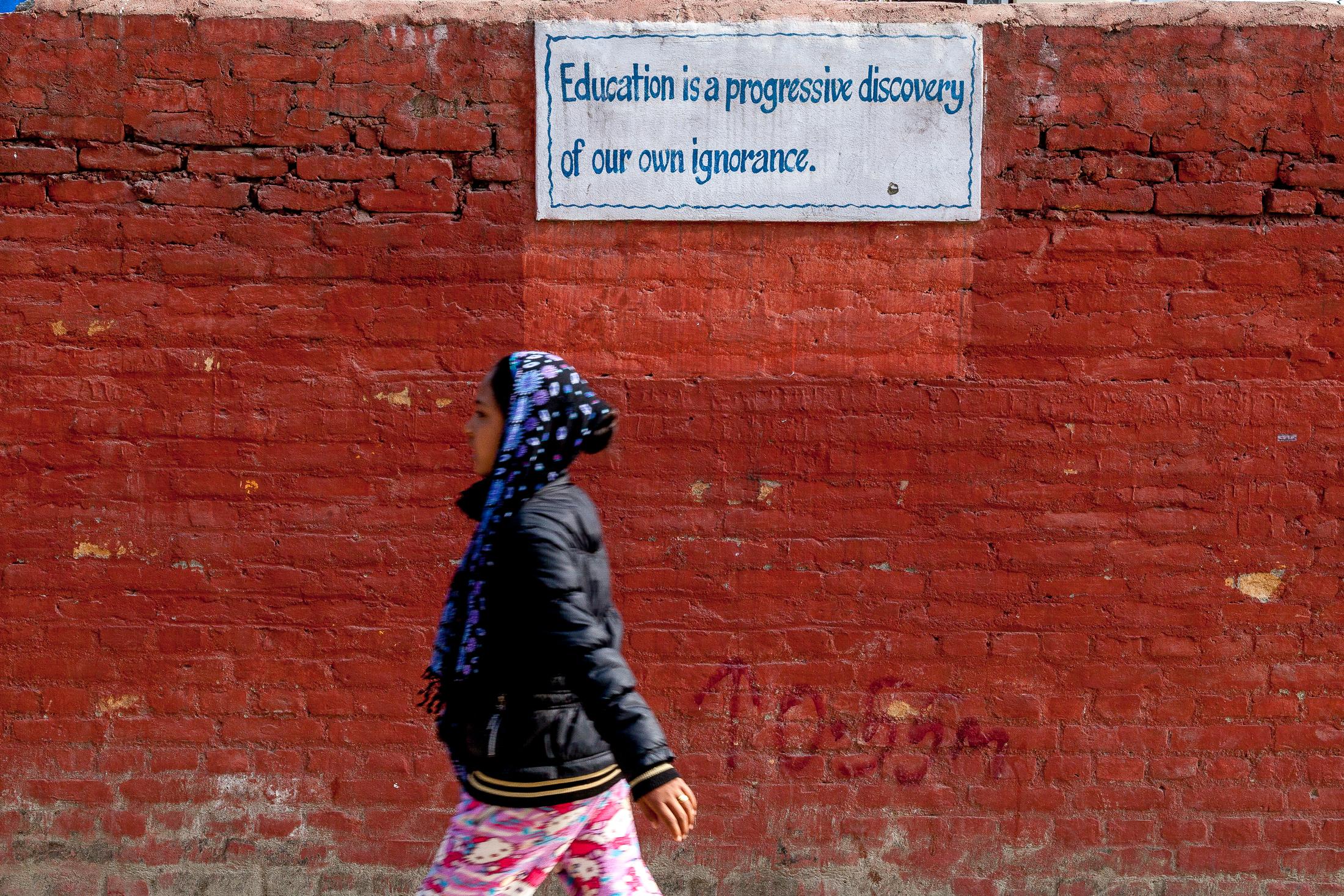 Portfolio NGO Education  - KATHMANDU, NEPAL - FEBRUARY 12: A young girl passes by a...