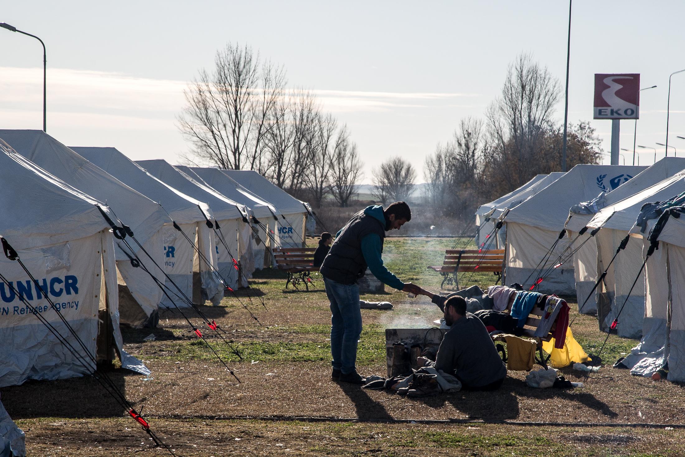 Portfolio NGO - POLIKASTRO, GREECE - FEBRUARY 11: Refugees warm up around...