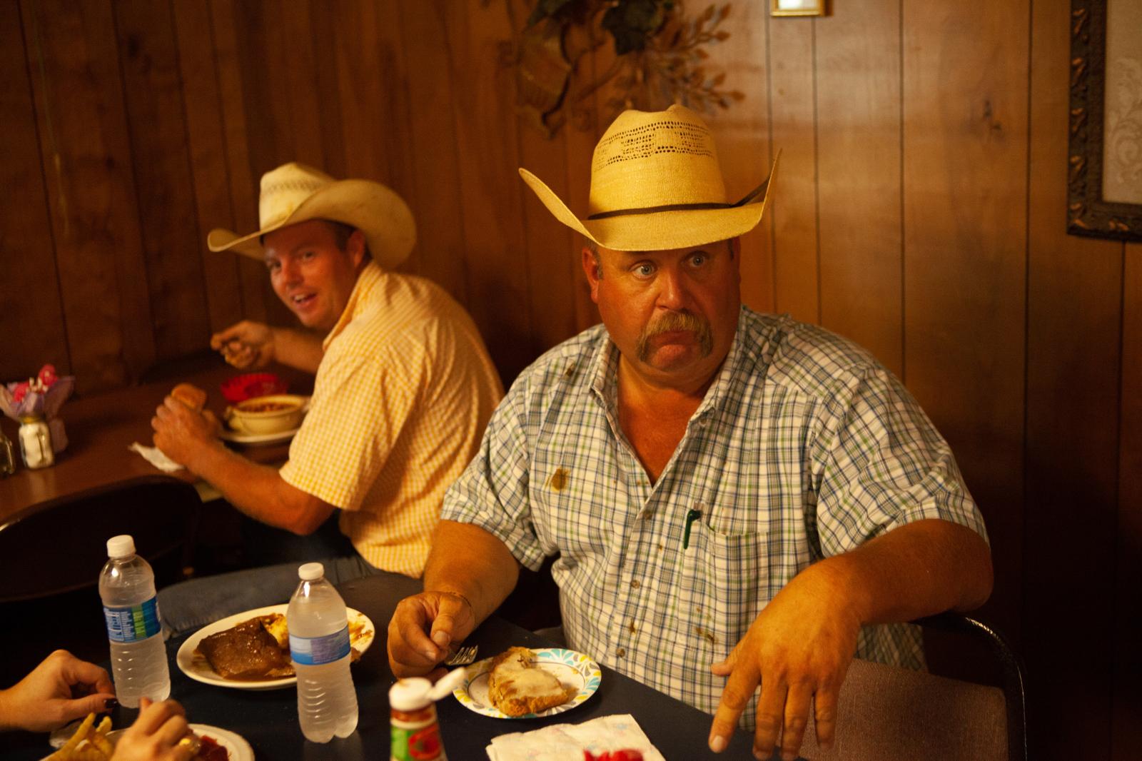 Cowboys having breakfast before a cattle auction.