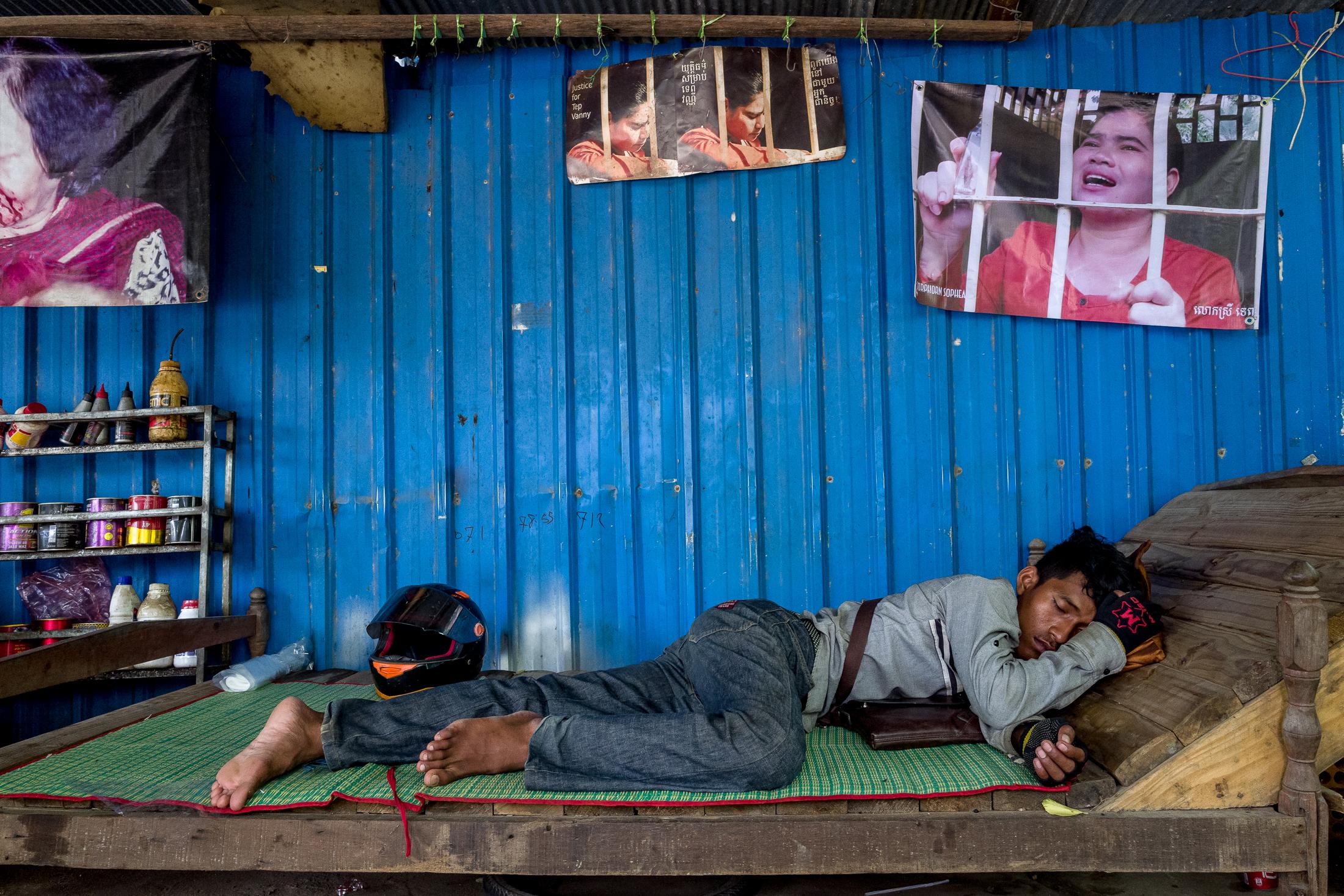 A woman's Cry: The detention of Tep Vanny - PHNOM PENH, CAMBODIA- SEPTEMBER 04: A young man sleeps in...