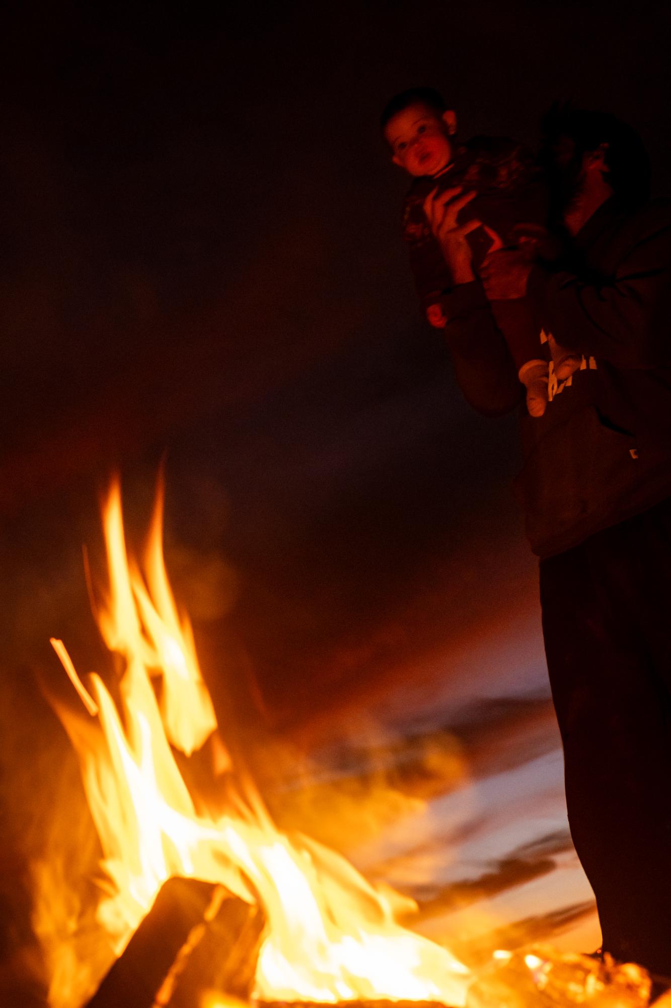 A Warm Winter (An Ongoing Journey) - Nilde and Conor watching the fire outside our rig....