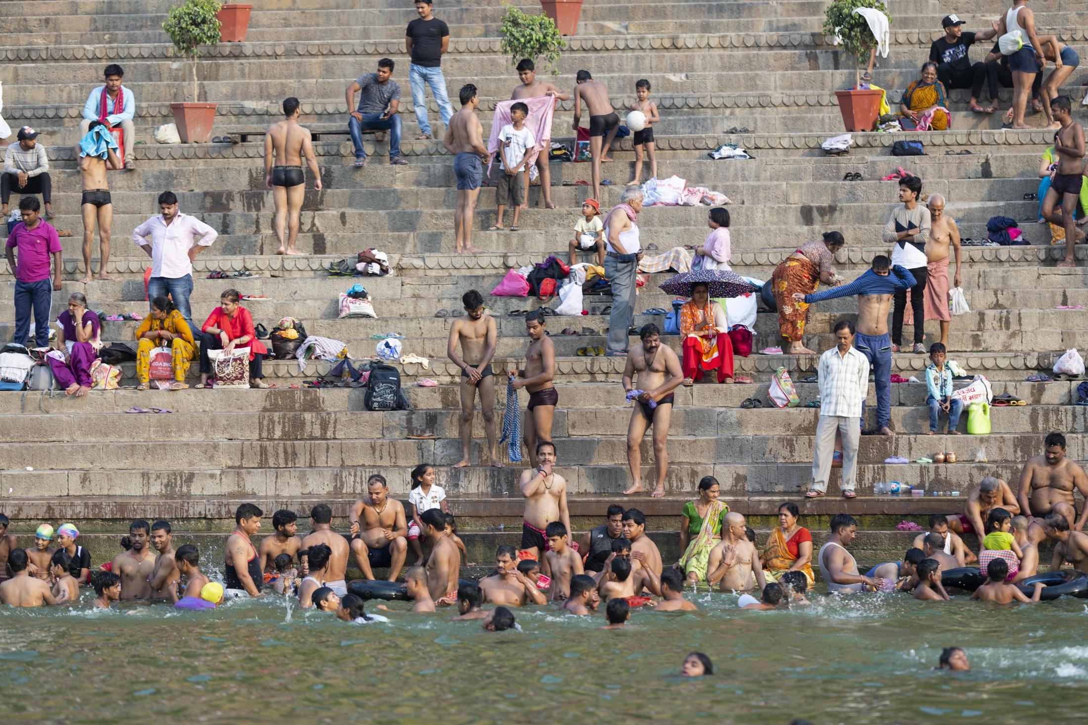 Identity Politics -  Devotees take a dip in the holy River Ganga in Varanasi,...