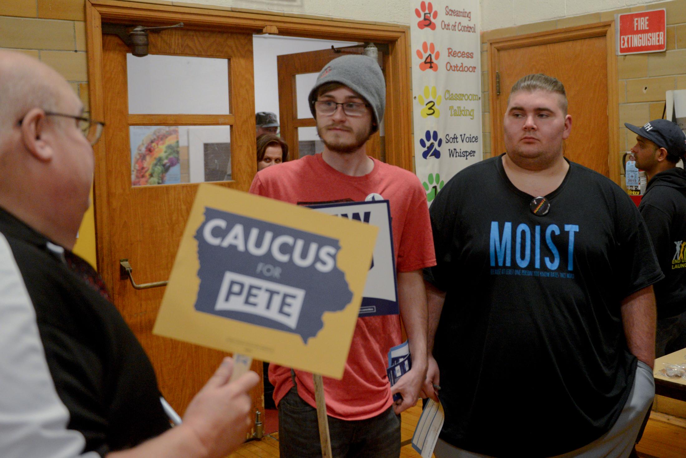 Iowa Caucus 2020 - Pete Buttigieg supporter Brad Berge (left) tries to...