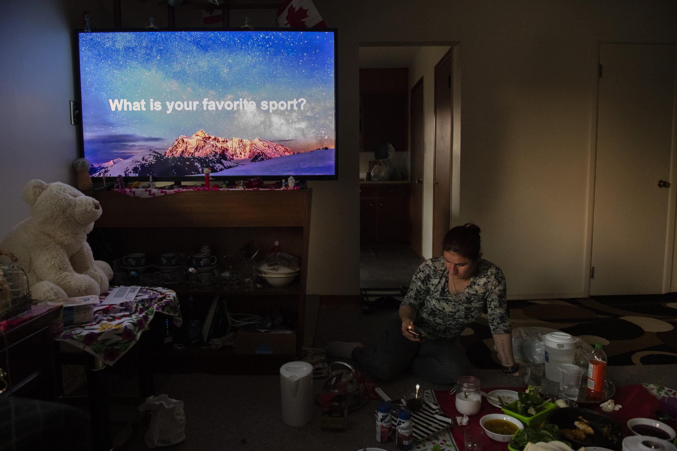 CALGARY | CANADA | 10/17/18 | Jihan (29) eats a late lunch after school while the TV is turned on, looping on English language learning Youtube channels. That's what the two sisters listen to all the time, repeating what they hear on TV. Jihan and Munifa are Yazidi refugees living in Calgary, arriving in Canada during the summer of 2017 as part of the Victims of Daesh program, a special resettlement program created by the Canadian government to help Yazidi refugees. 