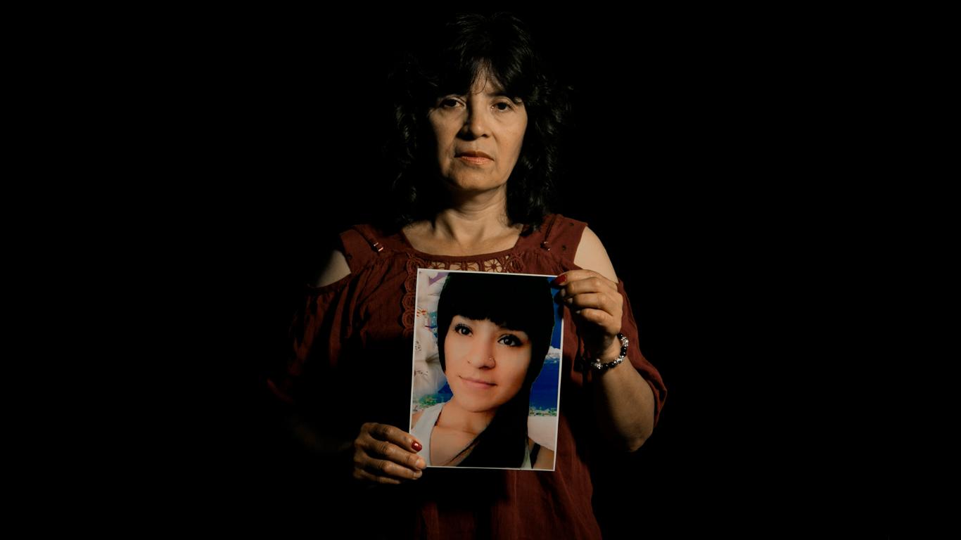 Desaparecidas, 2018 -  Norma Rivera holds the portrait of her daughter Shirley....