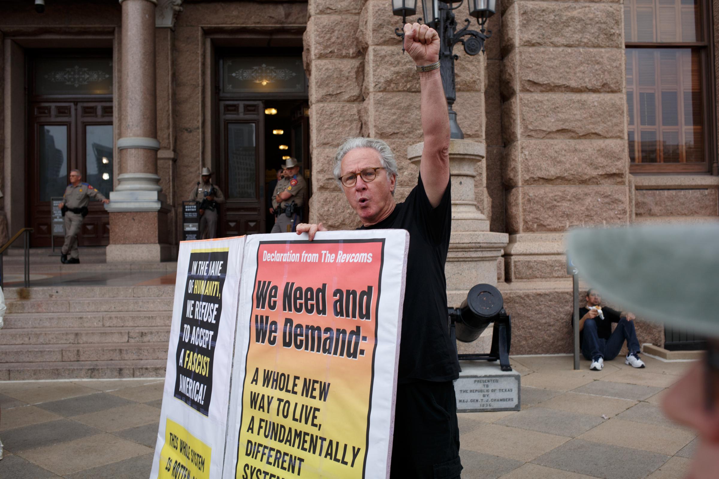 Protest Against the Trump Administration Policies Austin Texas February 05, 2025  - A member of REVCom ( Revolutonary Communists ) rises his fist in protest against the Trump...