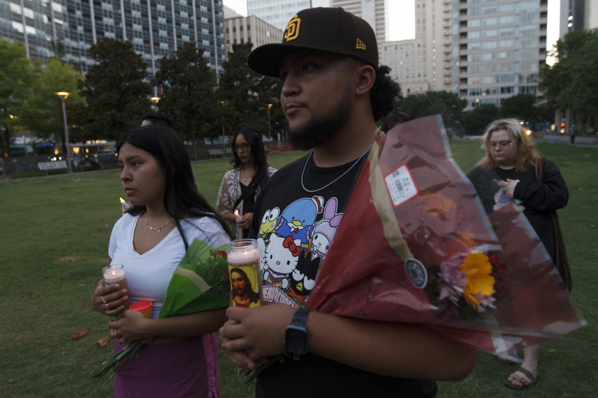 Candlelight Vigil for the Buffalo and Uvalde gun violence victims - Lindsey Rodriguez (left) and Pedro Andrade hold candles and flower during the candle vigil held...