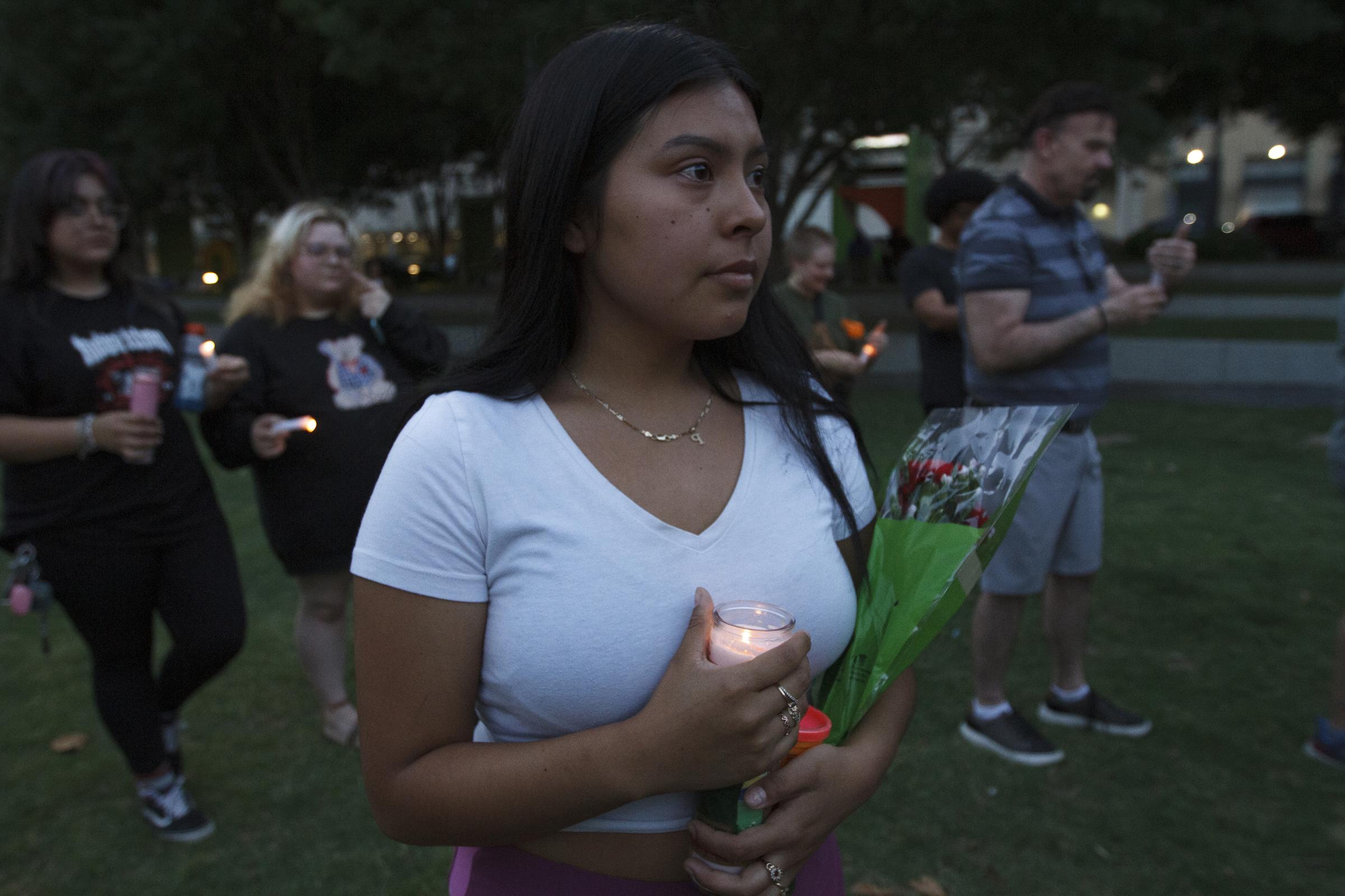 Candlelight Vigil for the Buffalo and Uvalde gun violence victims - Lindsey Rodriguez takes part in the candlelight vigil held at Main Street Garden in downtown...