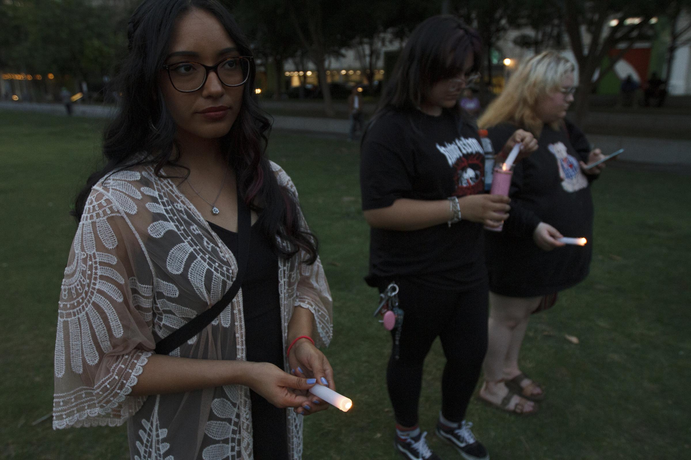 Candlelight Vigil for the Buffalo and Uvalde gun violence victims - Desiree Martinez a UCLA student attends the candlelight vigil at Main Street Garden in Dallas...