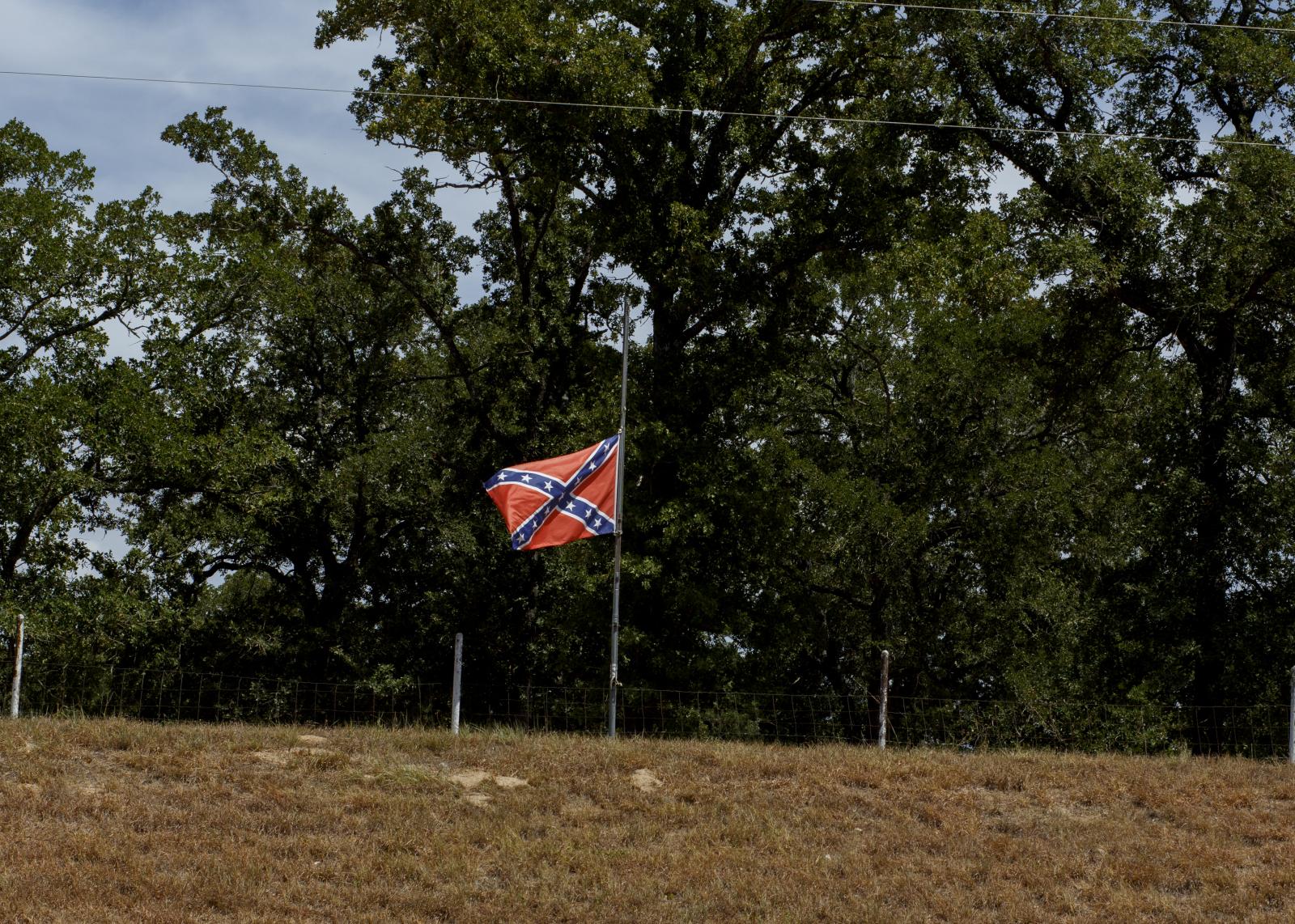 Confederate flag flies on a hill by Texas state highway 77 near Rockdale Texas