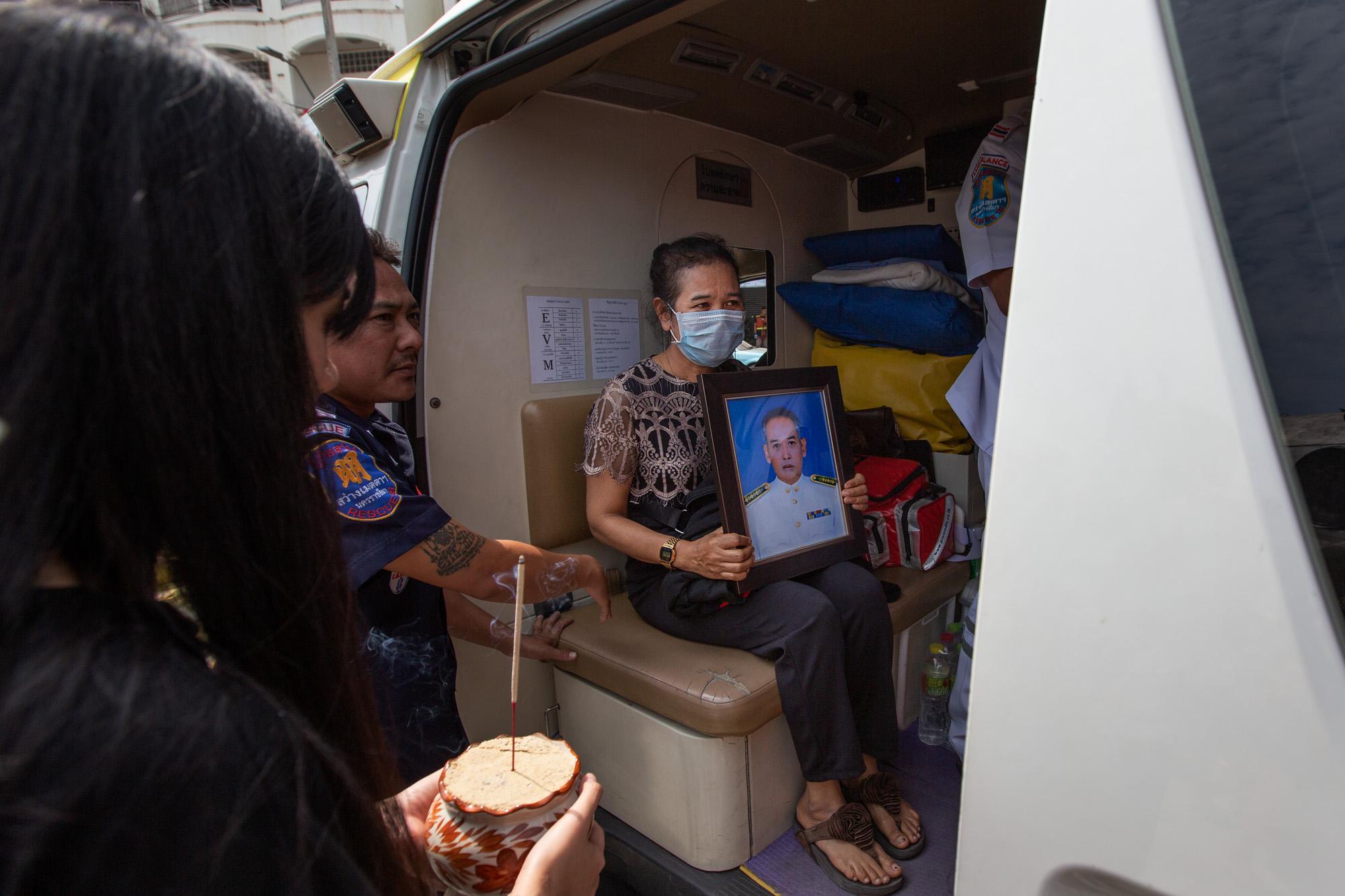 Shooting in Korat, Thailand: The New York Times - A woman holds a portrait of a loved one killed in the...