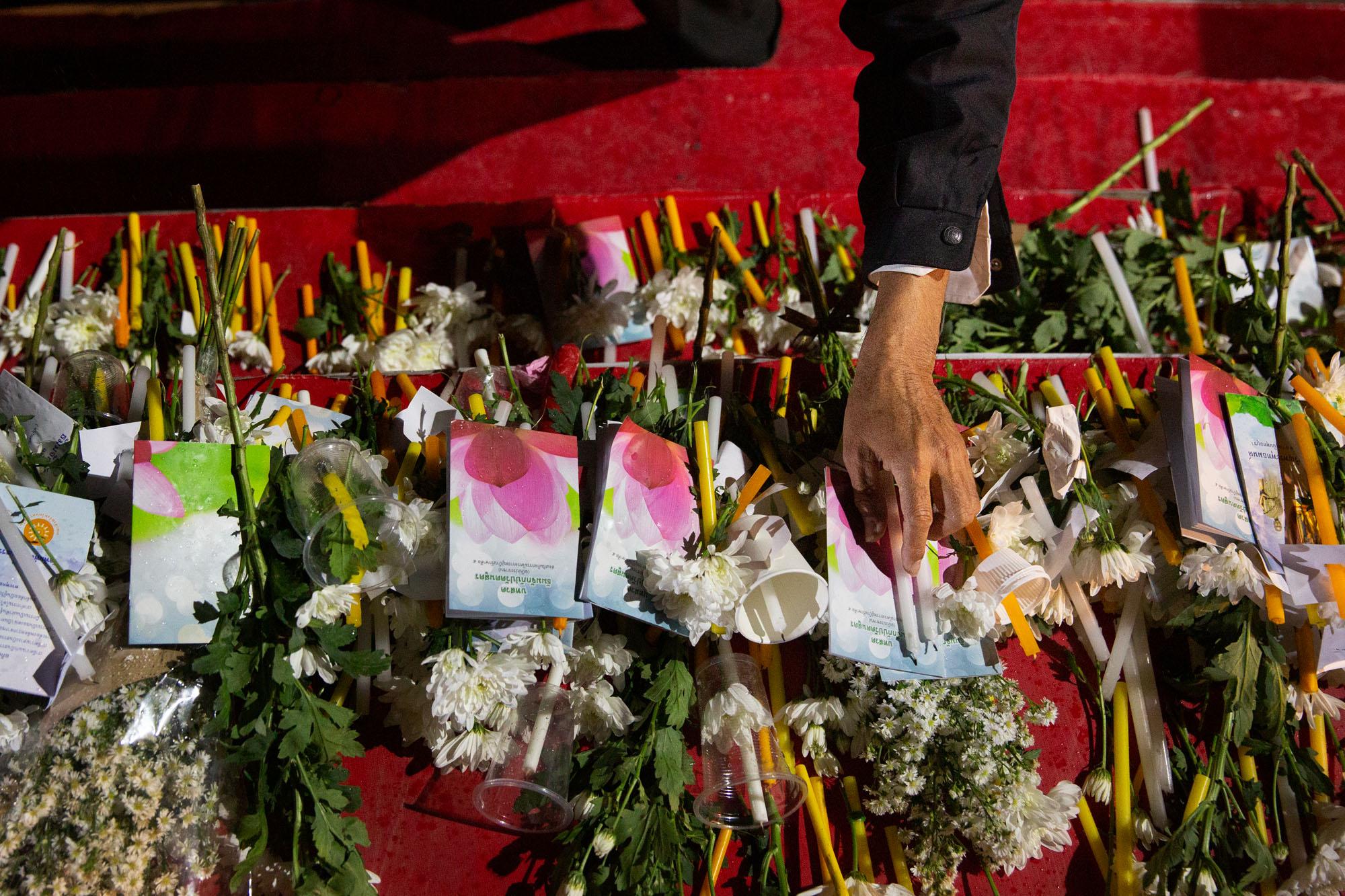 Shooting in Korat, Thailand: The New York Times - A man places a candle during a memorial for those killed...