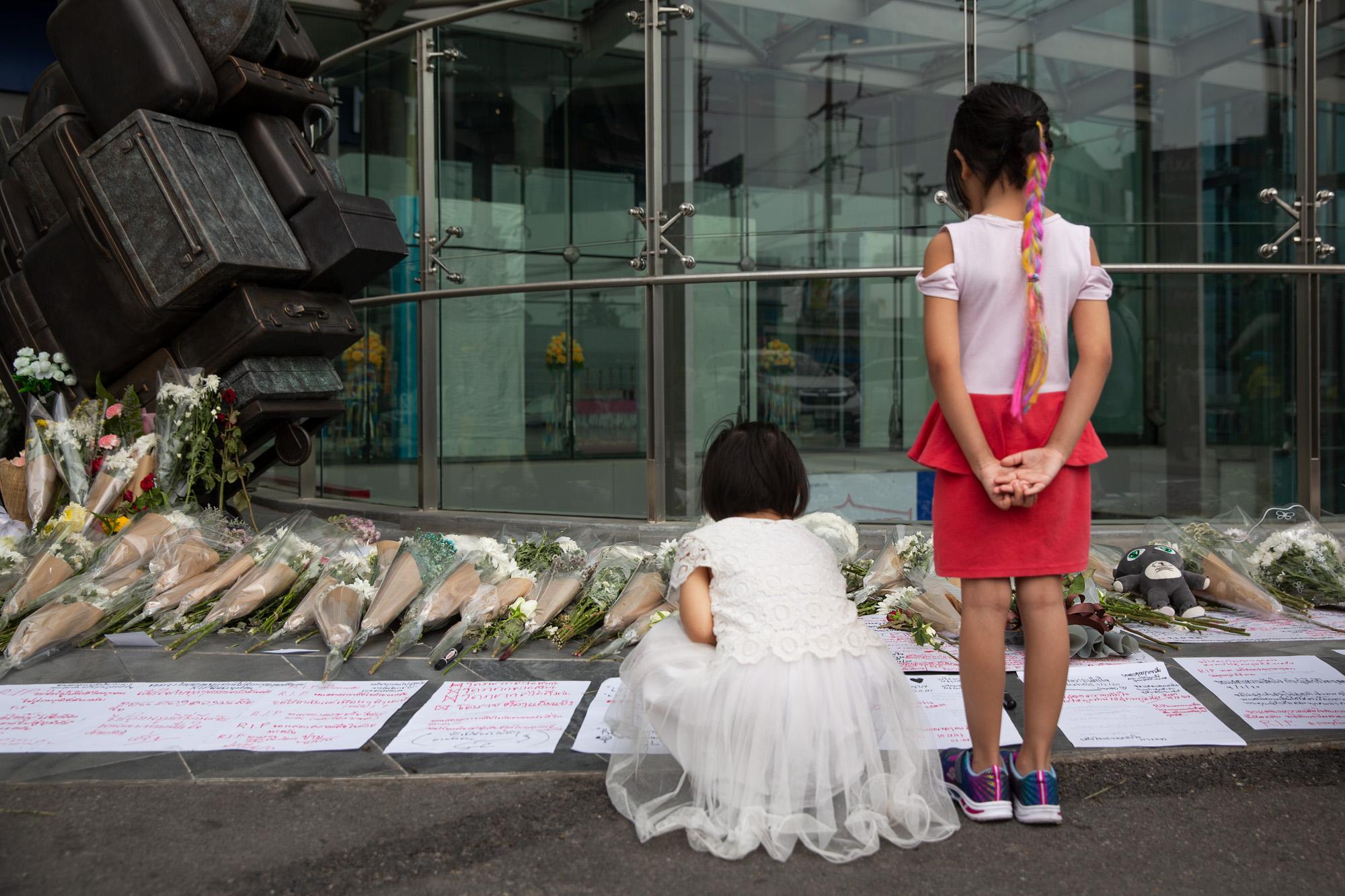 Shooting in Korat, Thailand: The New York Times - Two girls visit a memorial for those killed during the...