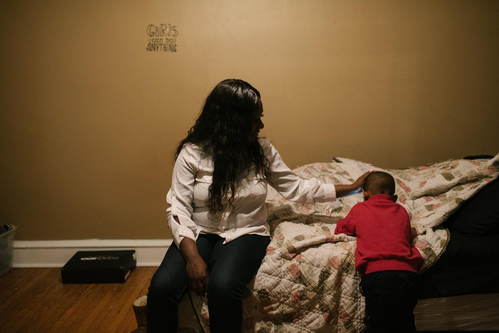 Shanaya Ball, 27, pats her son,...utism and developmental issues.