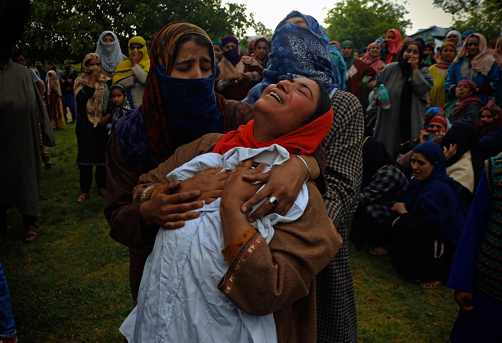 A woman wails while she hugs her 14 year old brotherï¿½s shirt (a ninth class student) who was killed by Indian armed forces during clashes that...