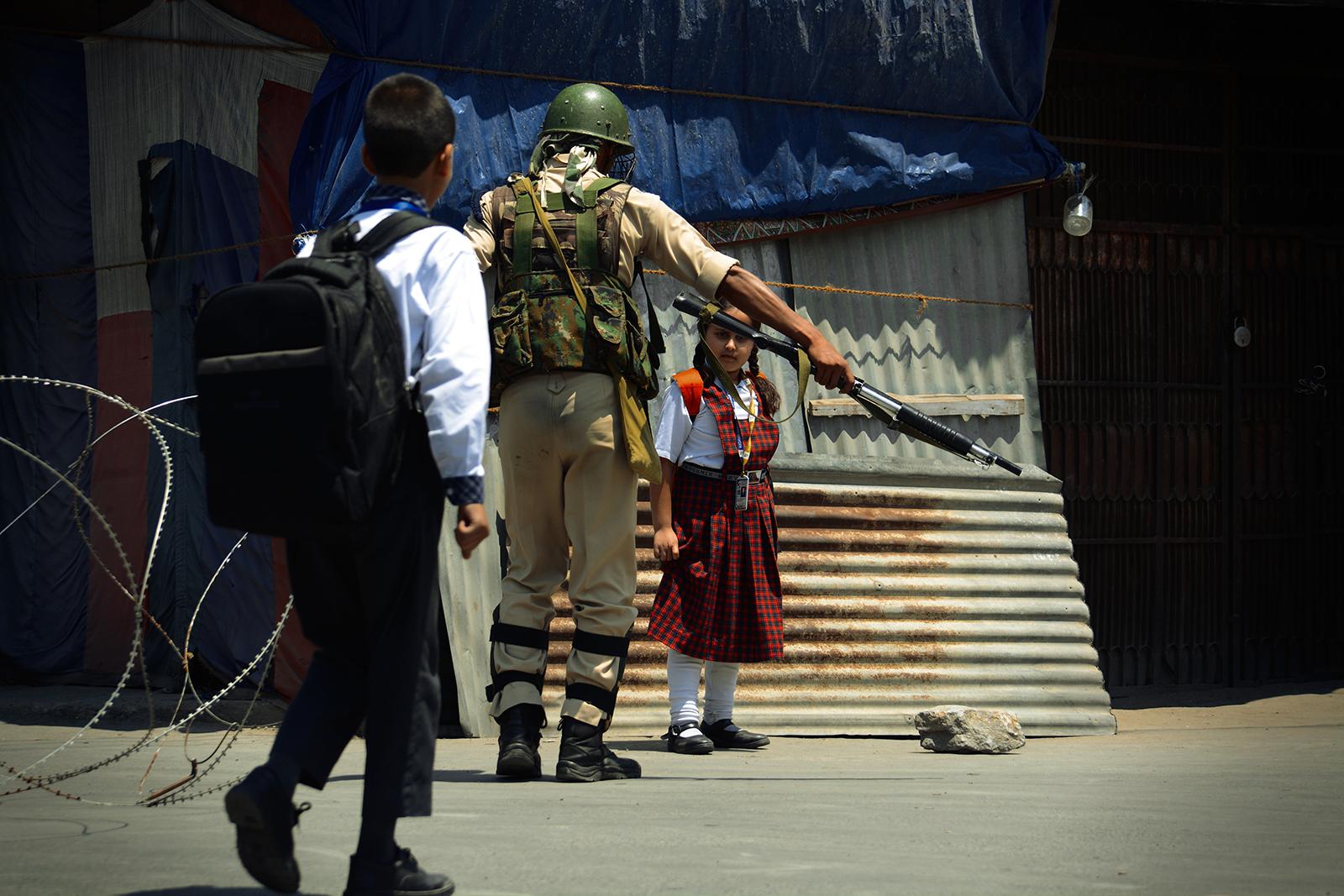 Kashmir-The Never Ending War - A Kashmiri school girl looks scarred after an Indian...