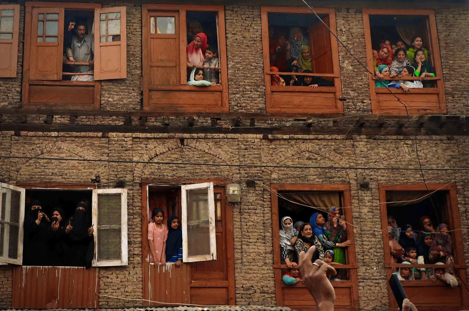 Kashmir-The Never Ending War - Women and children trying to have a glimpse of the...