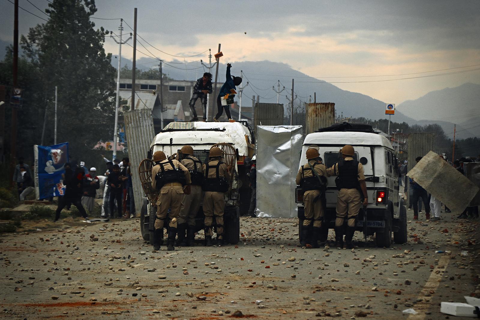 Kashmir-The Never Ending War - Youth hurl stones towards Indian police during clashes...