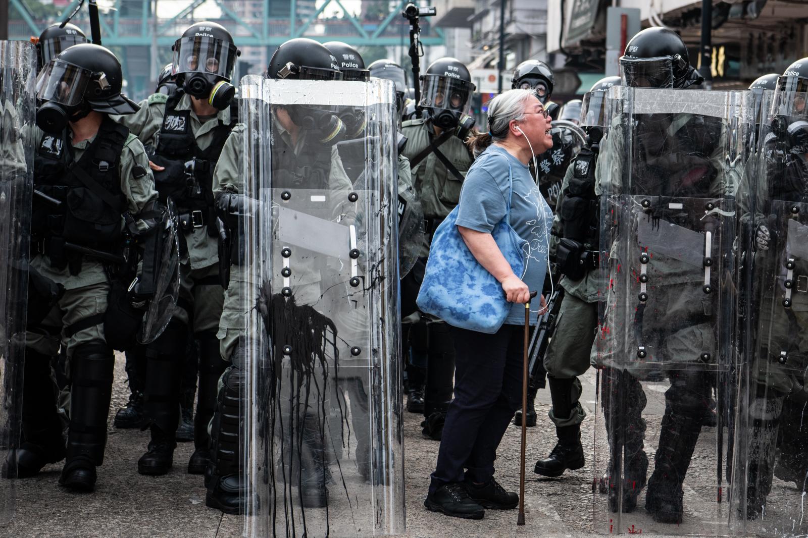 A woman shouts at riot police d...ackdown on protests. &nbsp;