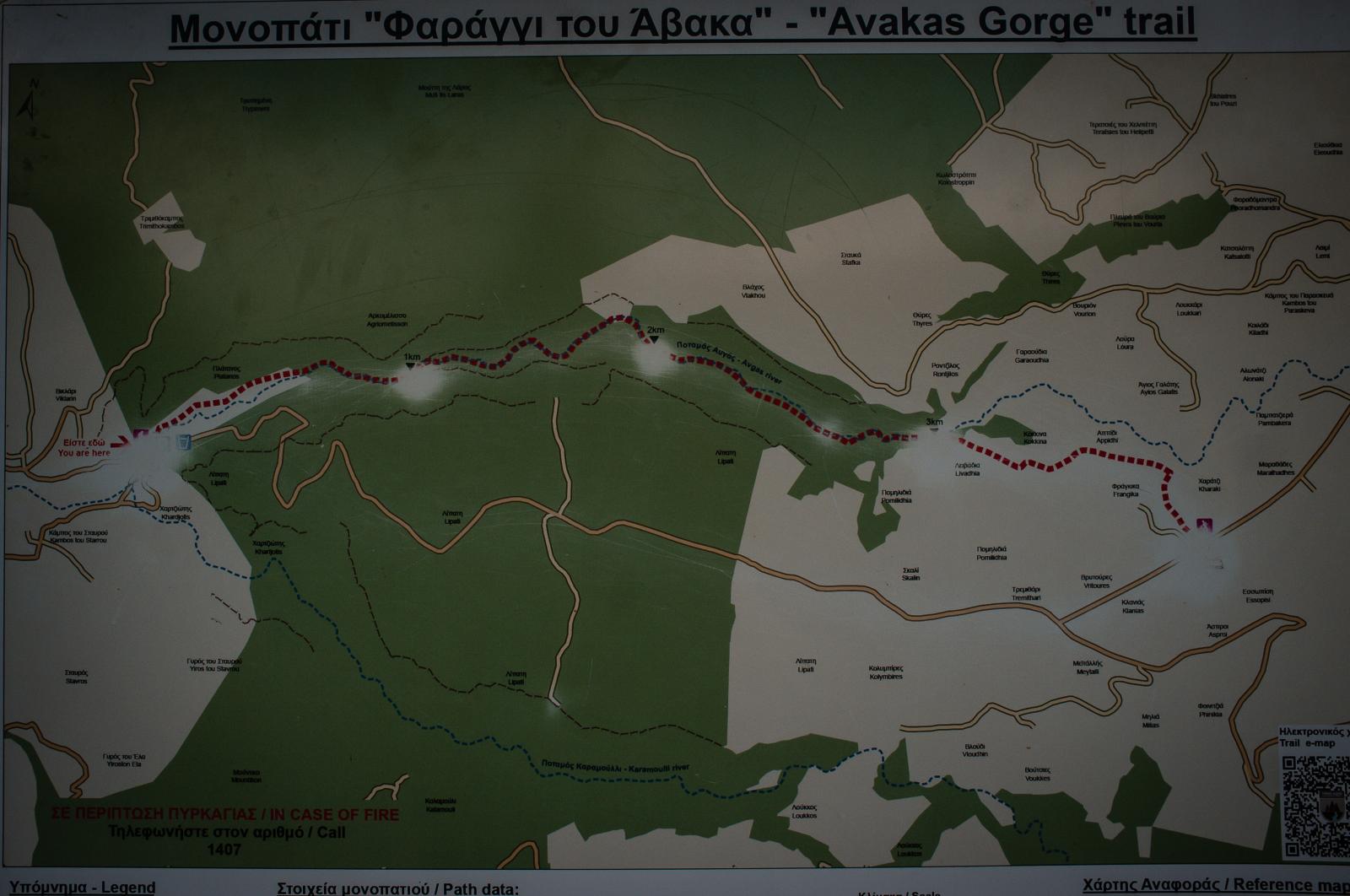 Sign indicating Avakas Gorge tr...tiful landscape and vegetation.