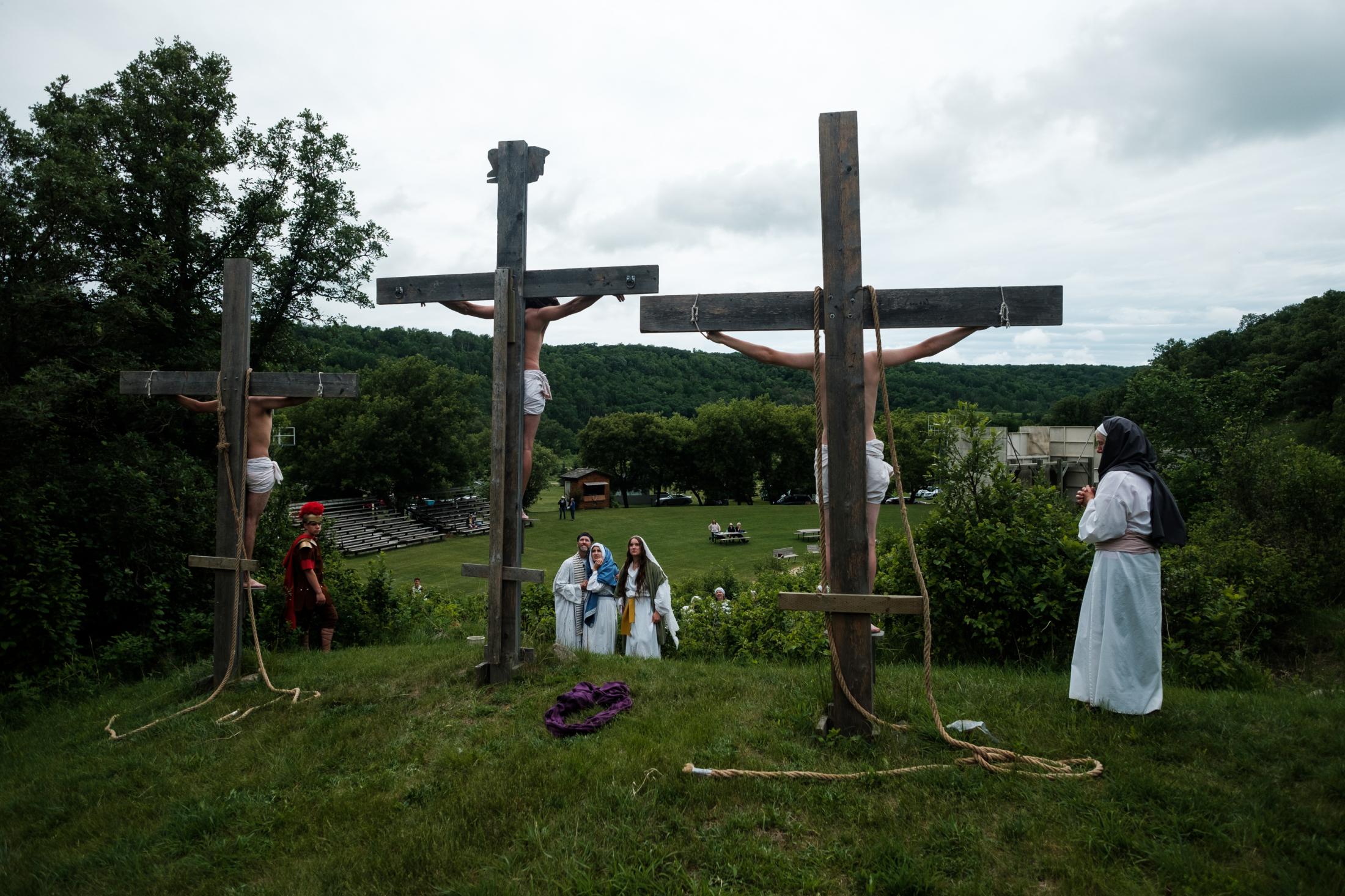 Singles - Volunteers reenact the crucifixion as they run through a...