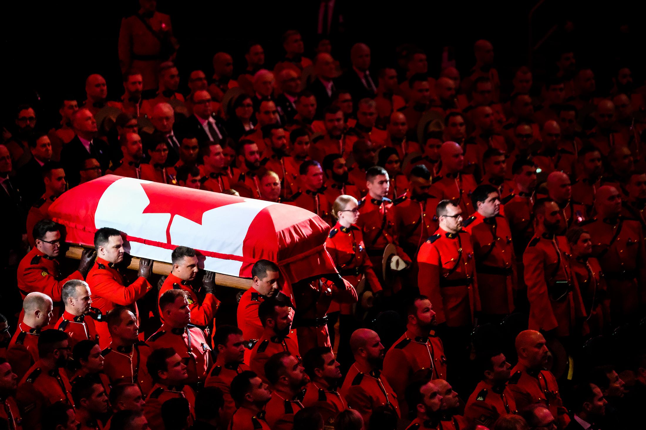 Singles - Pallbearers carry the flag draped coffin of RCMP Cst....