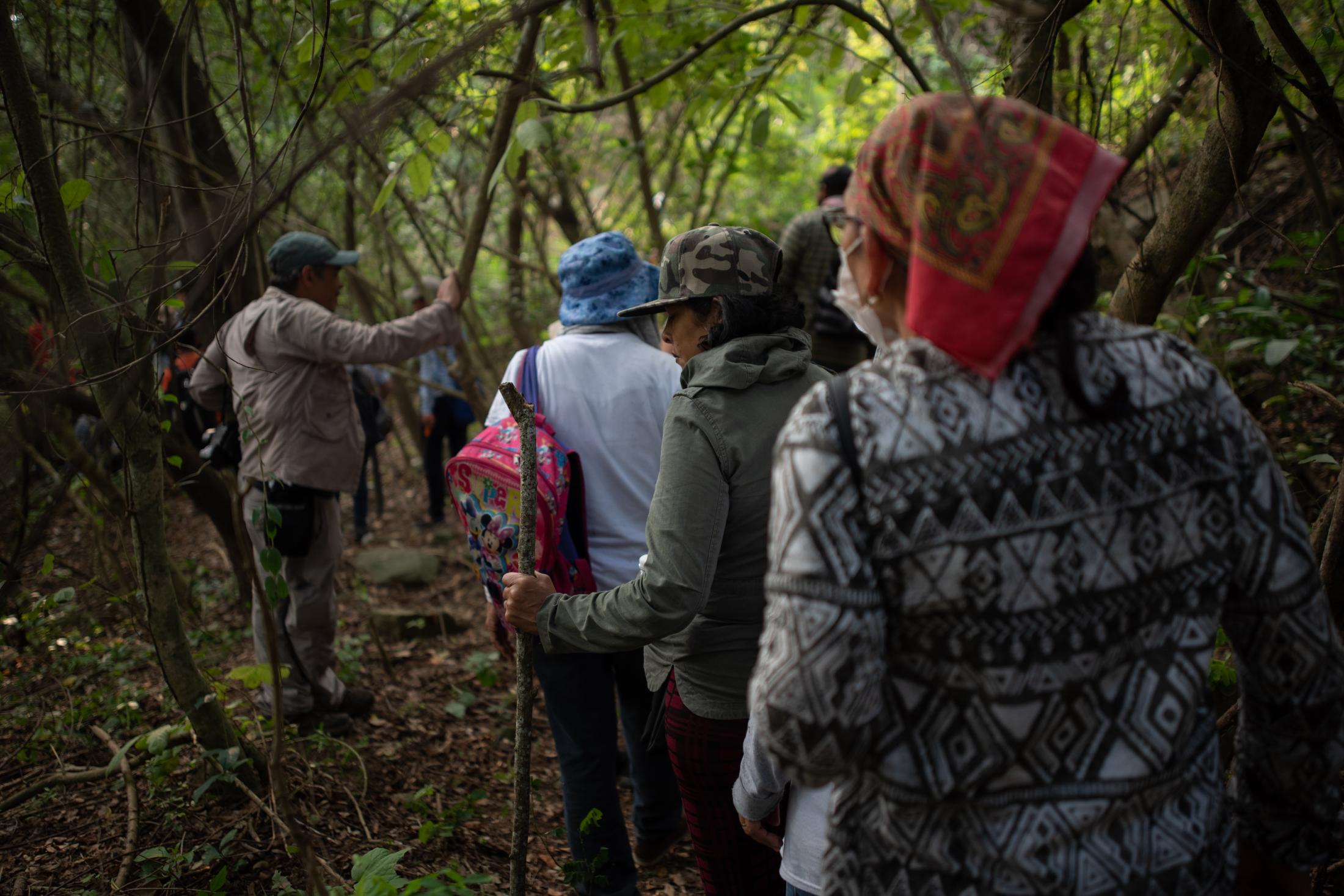 A group of seekers of missing persons walks through field that is investigated by police authorities and family groups participating in the fifth National Missing Persons Search Brigade in Tihuatlan, Veracruz, Mexico, on February 20, 2020. Victoria Razo for NPR
