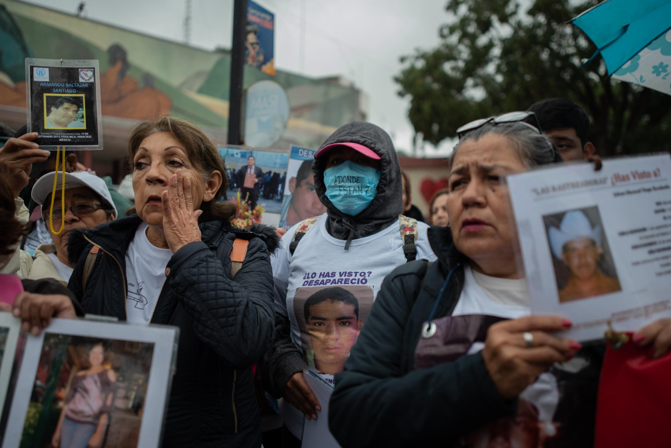 A group of women show portraits of their relatives during a demonstration of missing persons. Approximately 300 people participated in the fifth National Missing Persons Search Brigade in Poza Rica, Veracruz, Mexico, on February 21, 2020. Victoria Razo for NPR