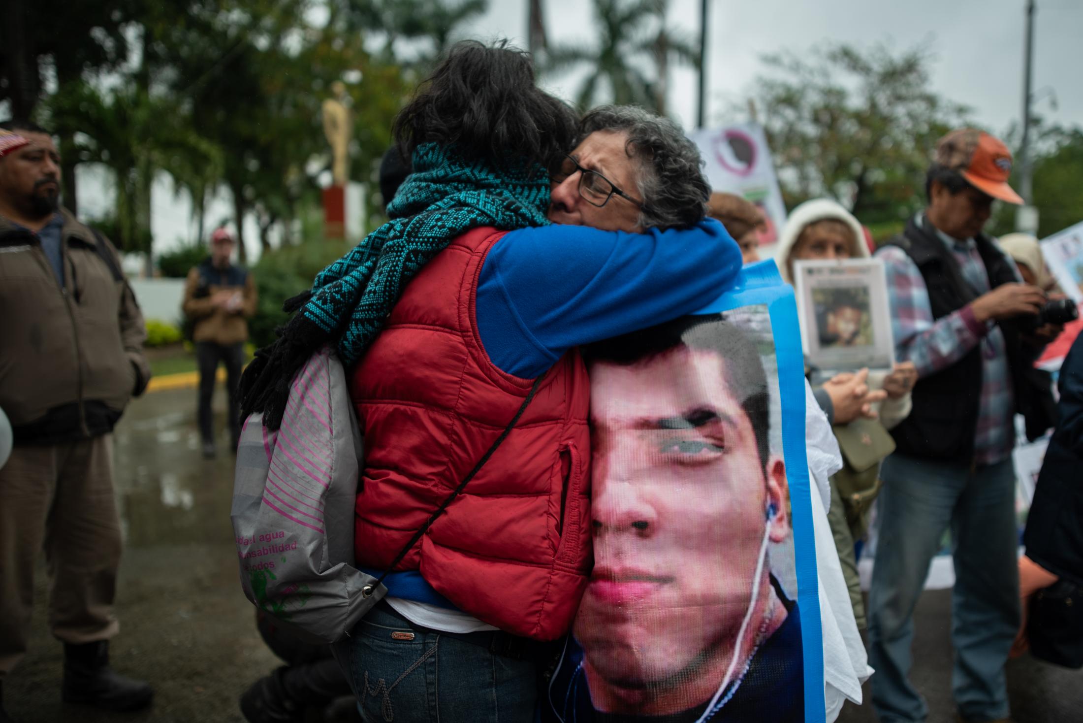 Two women cries during a demonstration of missing persons. Approximately 300 people participated in the fifth National Missing Persons Search Brigade in Poza Rica, Veracruz, Mexico, on February 21, 2020. Victoria Razo for NPR
