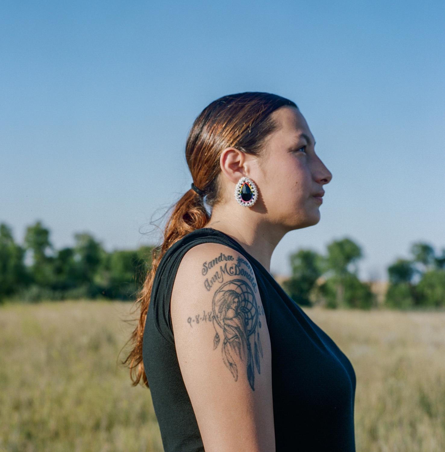The Bakken oil shale's impact on Native American women - Heather Belgrade, 23, shows a tattoo of her grandmother,...