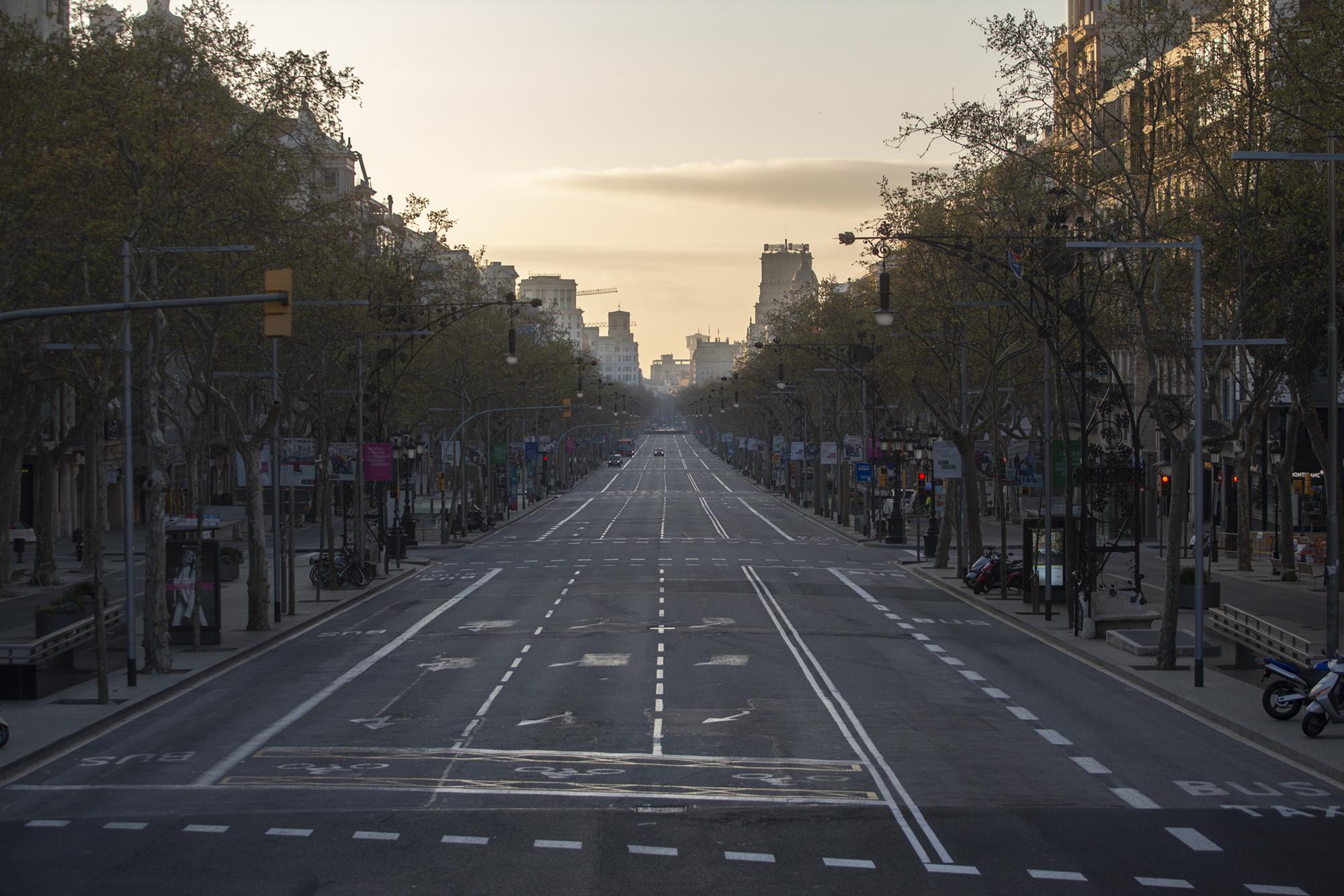 An avenue is seen empty in Barcelona, Spain, Sunday, March 15, 2020. Spain&#39;s government announced Saturday that it is placing tight restrictions on movements and closing restaurants and other establishments in the nation of 46 million people as part of a two-week state of emergency to fight the sharp rise in coronavirus infections. For most people, the new coronavirus causes only mild or moderate symptoms. For some, it can cause more severe illness, especially in older adults and people with existing health problems. (AP Photo/Joan Mateu)
