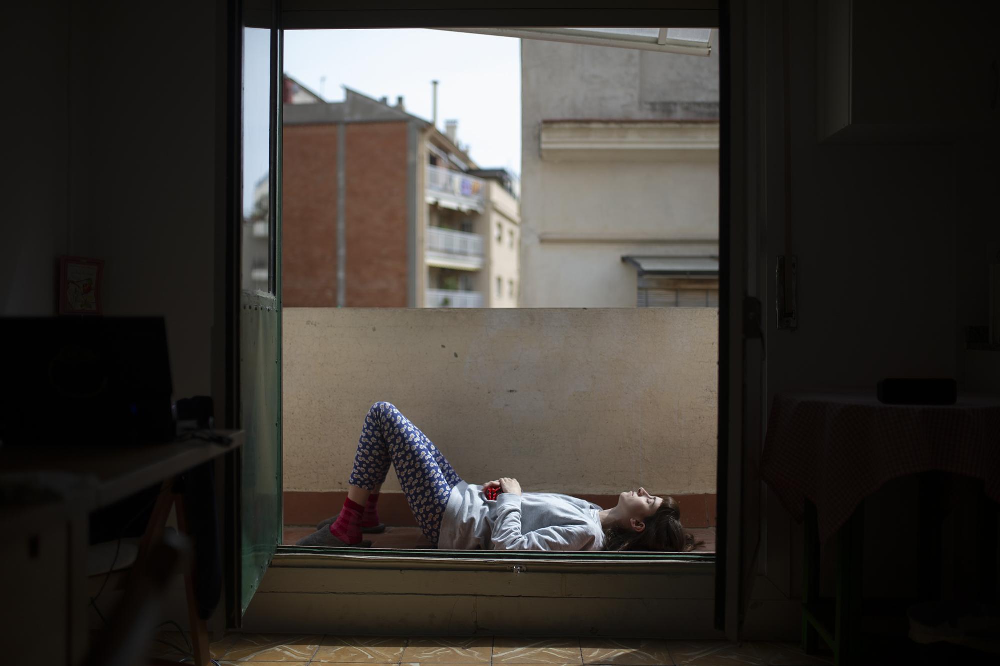 Covid 19 Daily News - Clara sunbathes during Spanin's lockdown. Spain's...