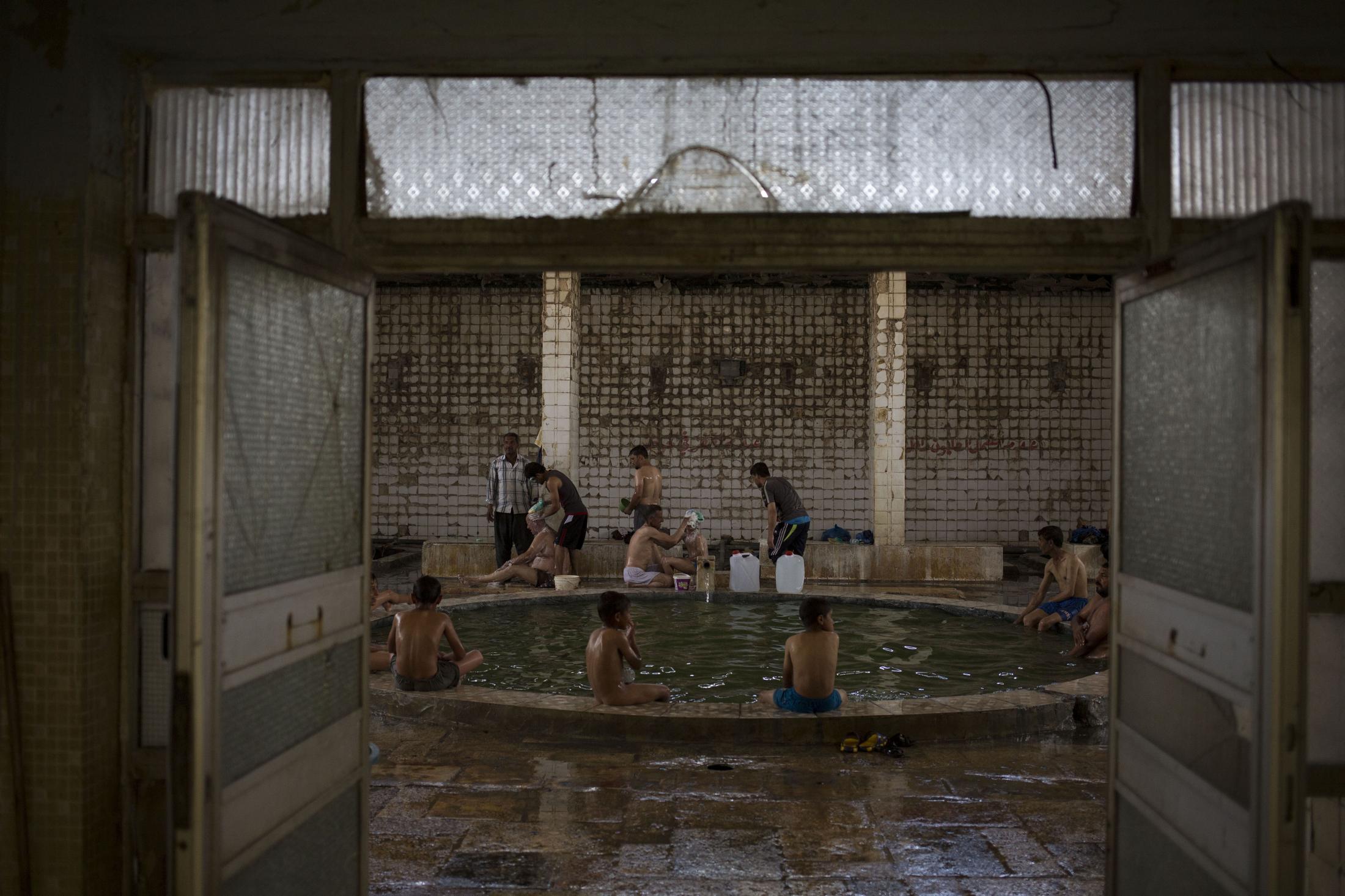 A Spa in Wartime - Customers enjoy the Hamam Alil sulphur spa, situated in...