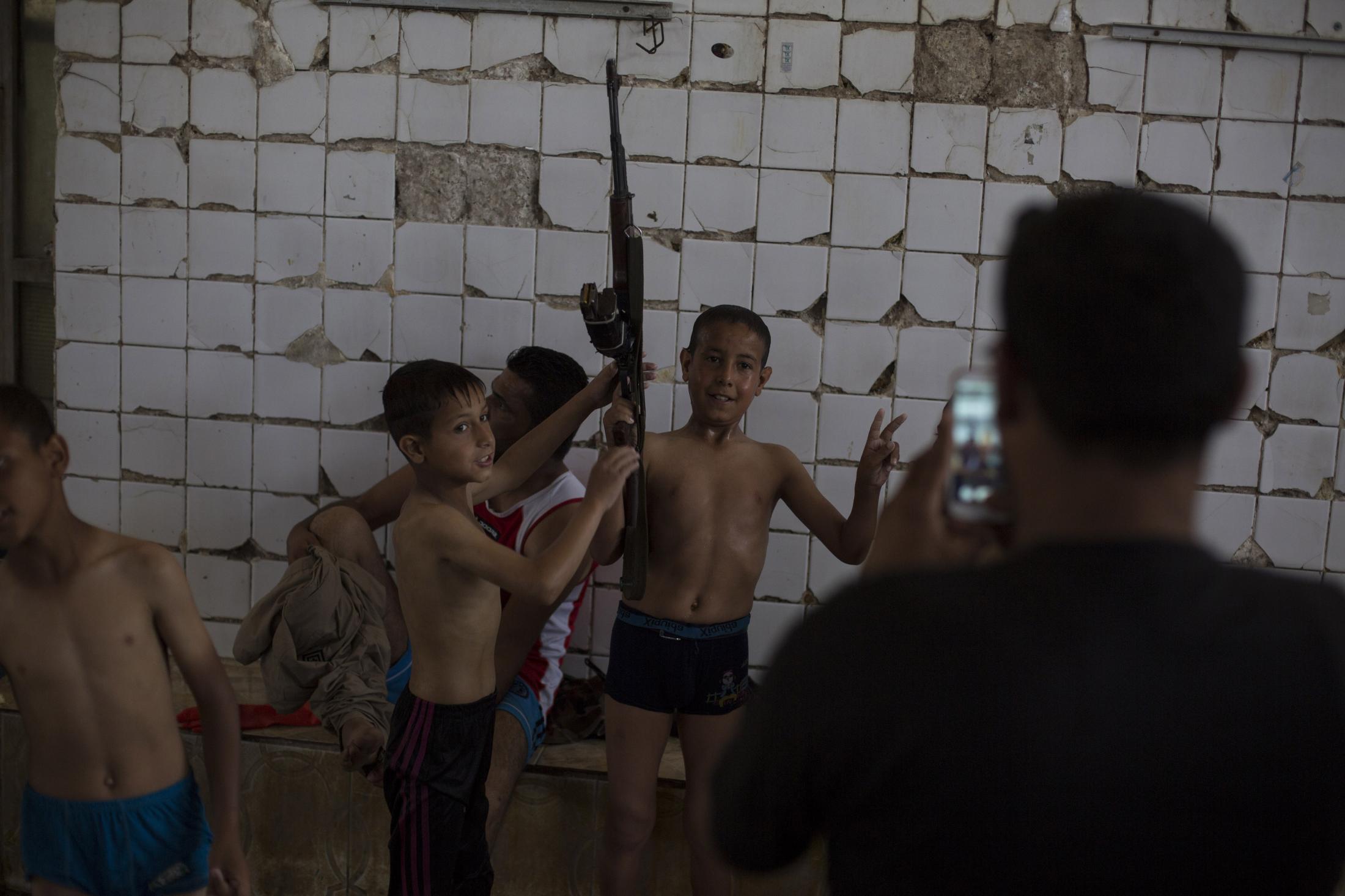 A Spa in Wartime - Children in the Hamam Alil spa south of Mosul, Iraq, pose...