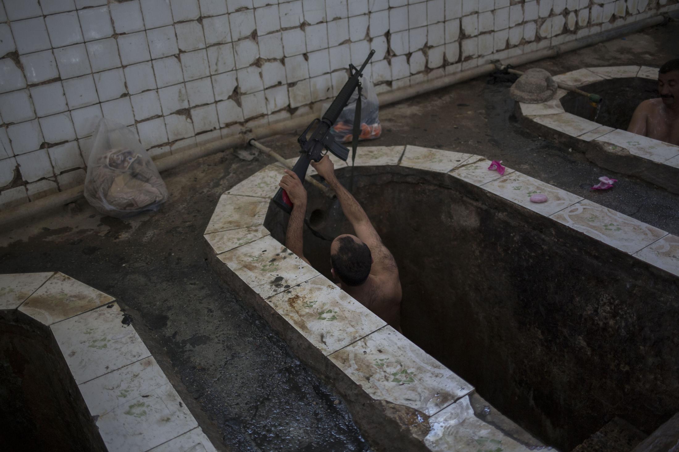 A Spa in Wartime - A federal police officer takes a bath in the Hamal Alil...