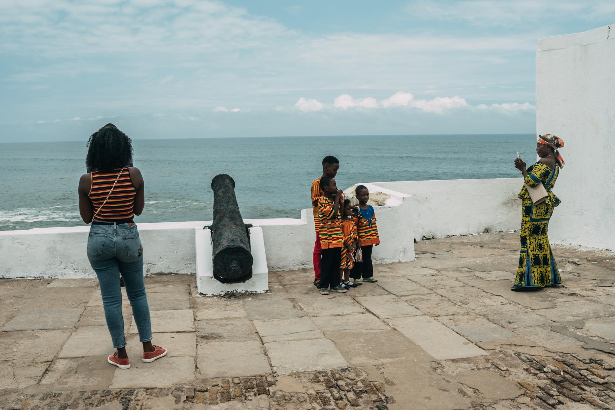 The Year of Return - Tourists and locals take pictures at the Cape Coast...