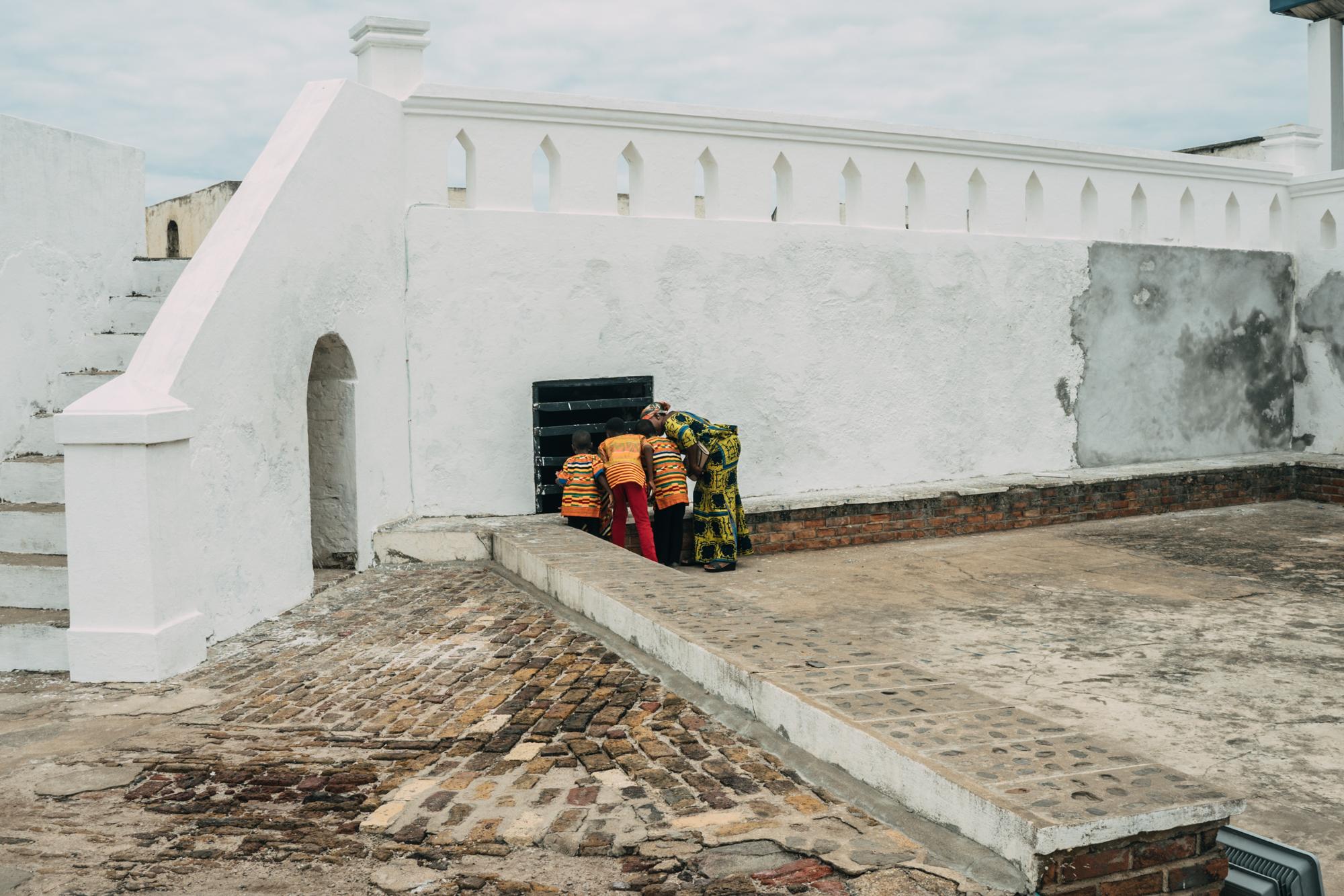 The Year of Return - Mother and her kids look inside the Cape Coast Castle...