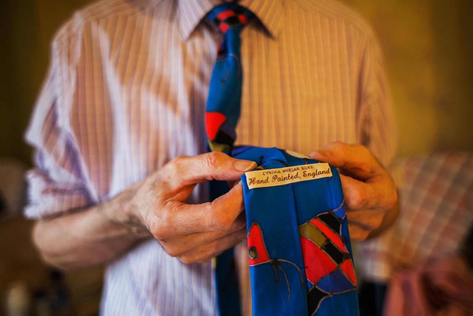 LONDON, UNITED KINGDOM - MARCH 28, 2013: George shoes the label of his tie that he bought for a...