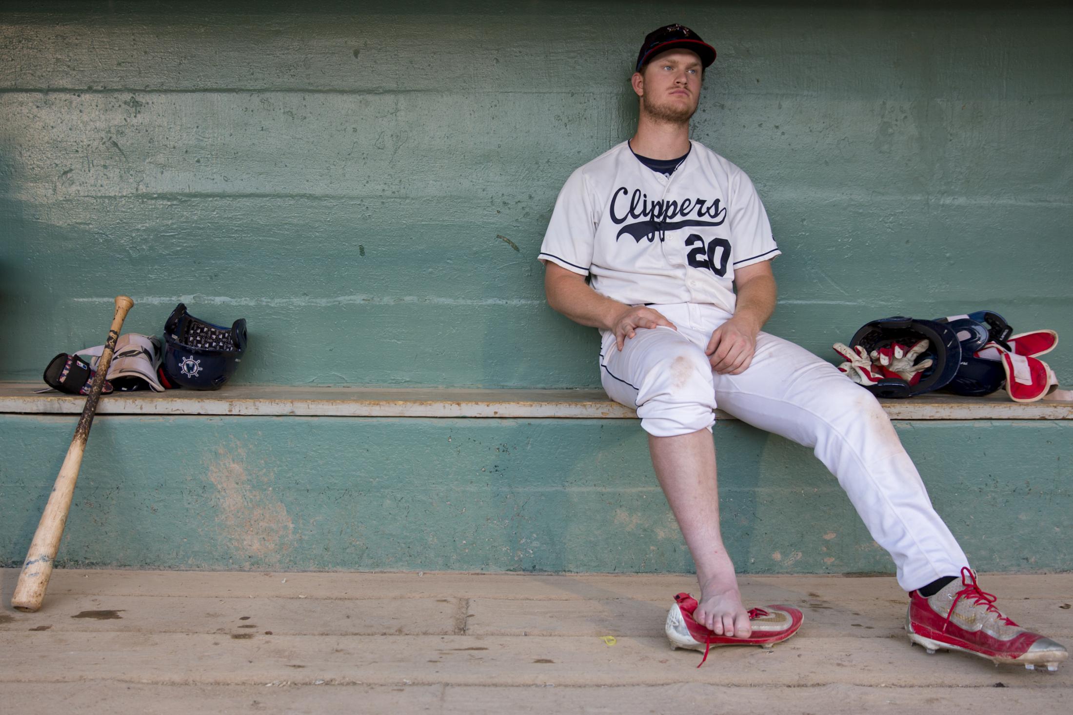 People - Muskegon Clippers Peter Zimmermann rests in the dugout...