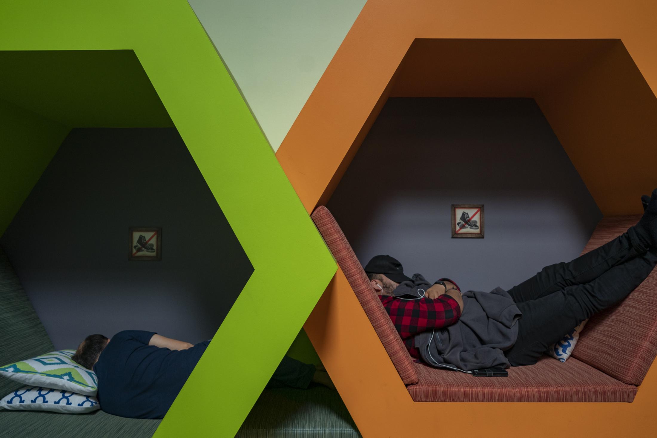 Singles - Employees rest inside "napping pods" at...