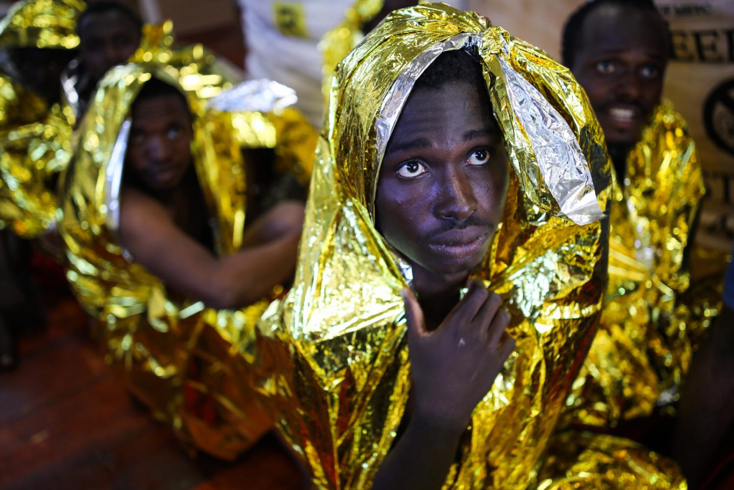 Nigerian Refugees wrap themselv...ves of four migrants.&nbsp;