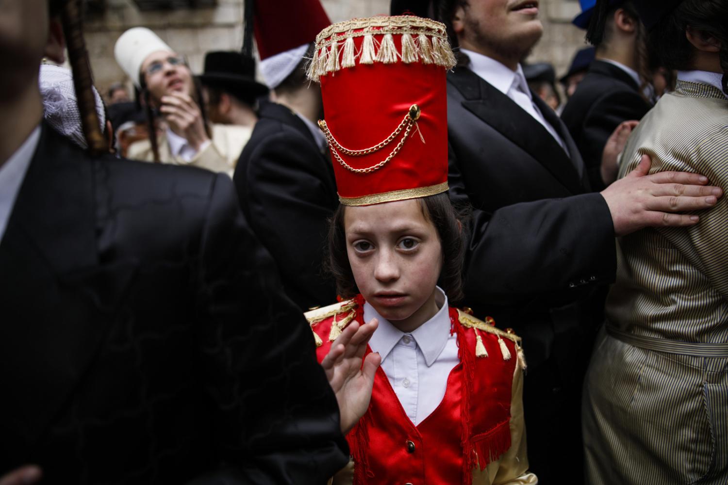 Ultra-Orthodox Jews wearing cos...ecounted in the Book of Esther.