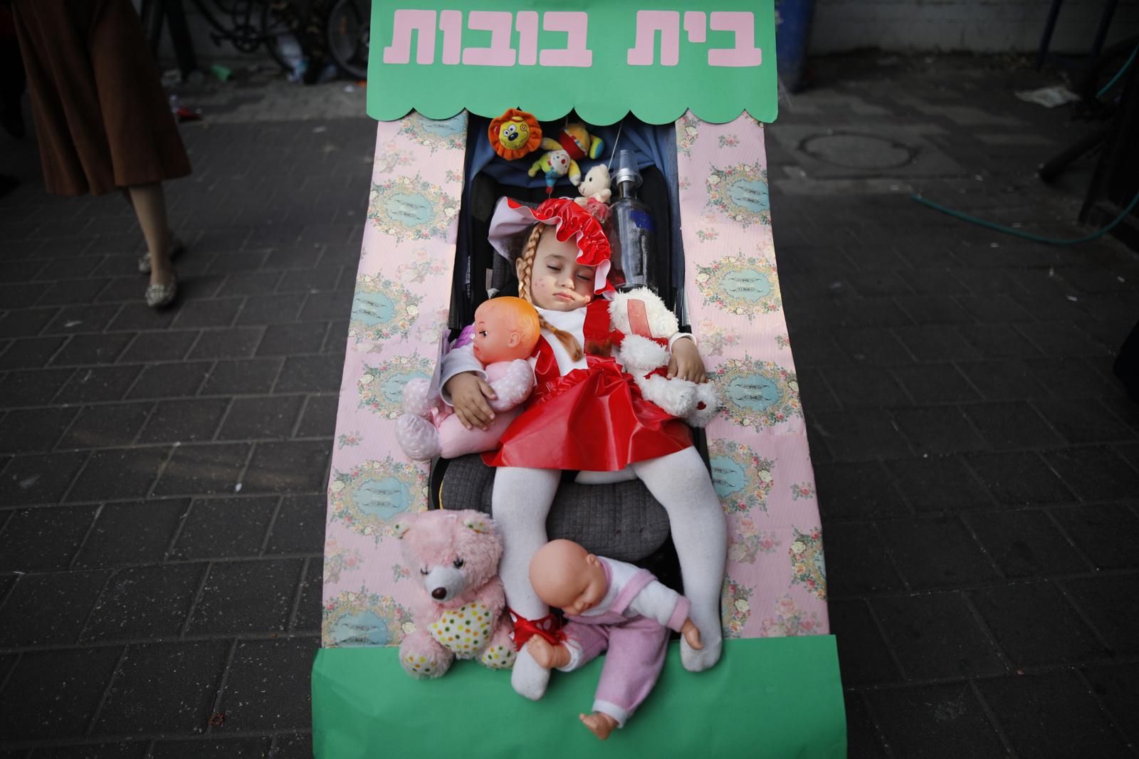 Ultra-Orthodox Community - A girl, dressed in a costume is seen during Purim, a...