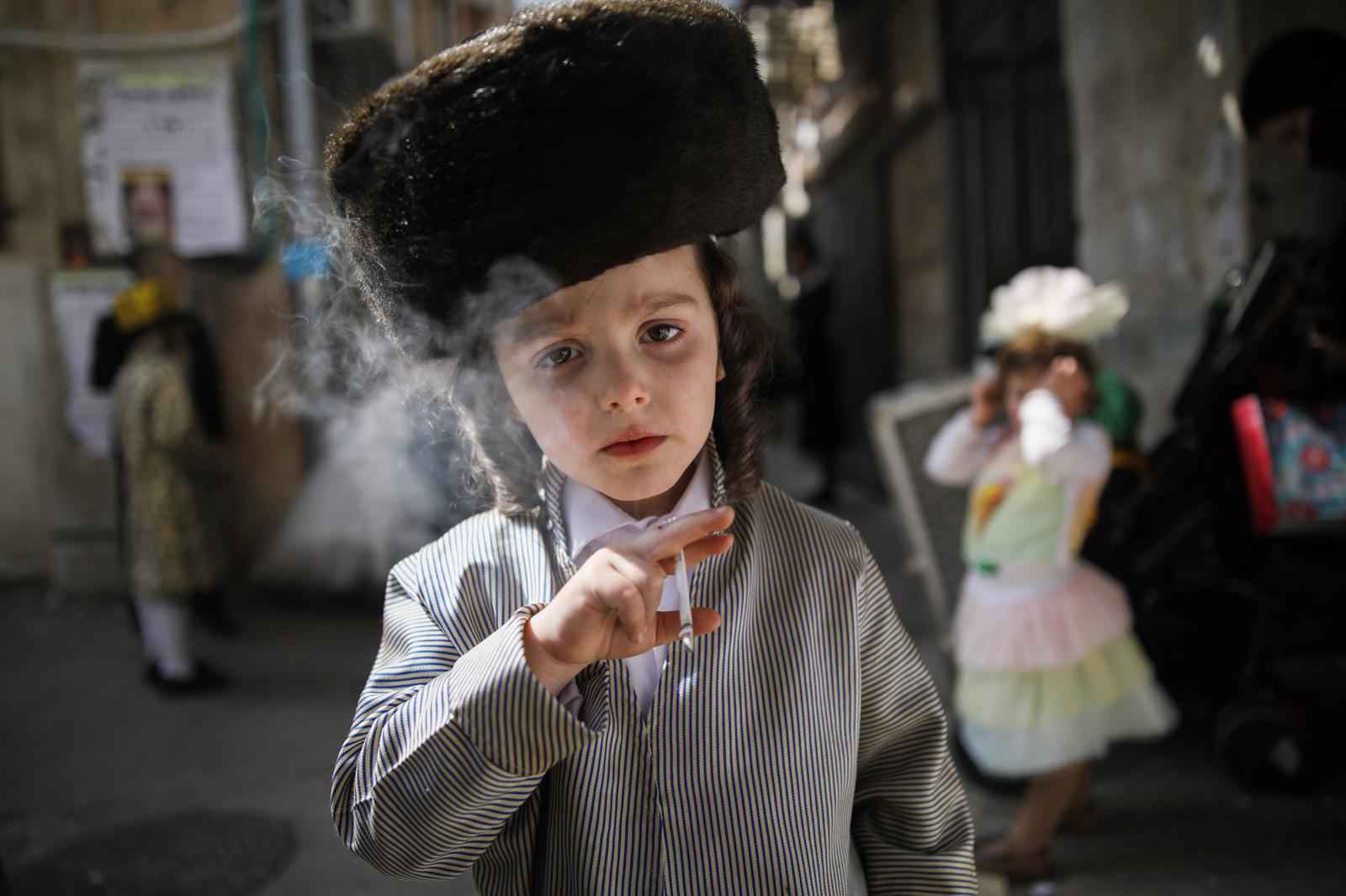 Ultra-Orthodox Community - An ultra-Orthodox Jewish boy smokes a cigarette during...