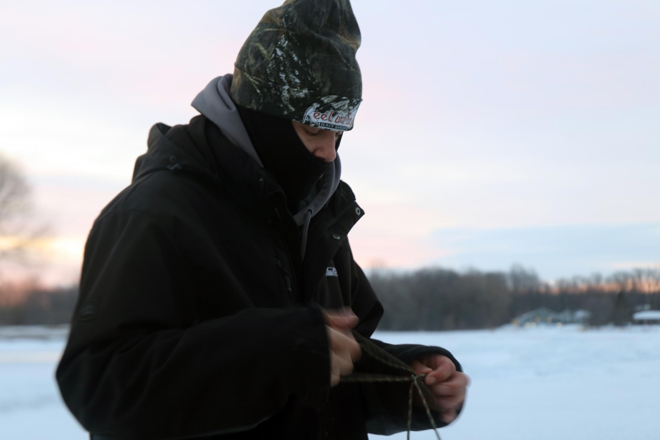 Morning on Ice - Kahnawake, MT - March 8, 2020: Diabo ties his rope from...