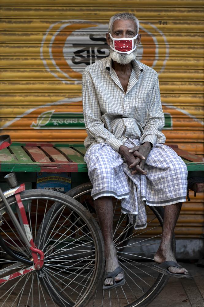 Mojammel Haque (60) poses for a... to see his crying as a father.