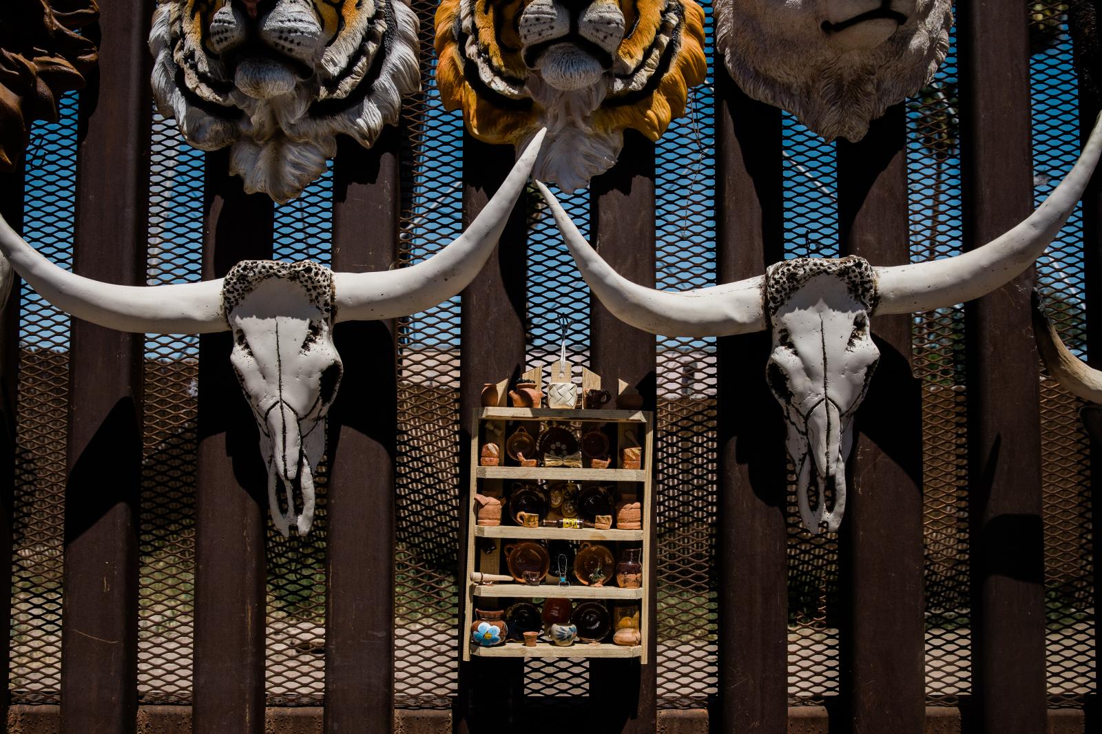 Souvenirs are displayed on the border fence the divides the US and Mexico in Mexicali on April 4, 2019.