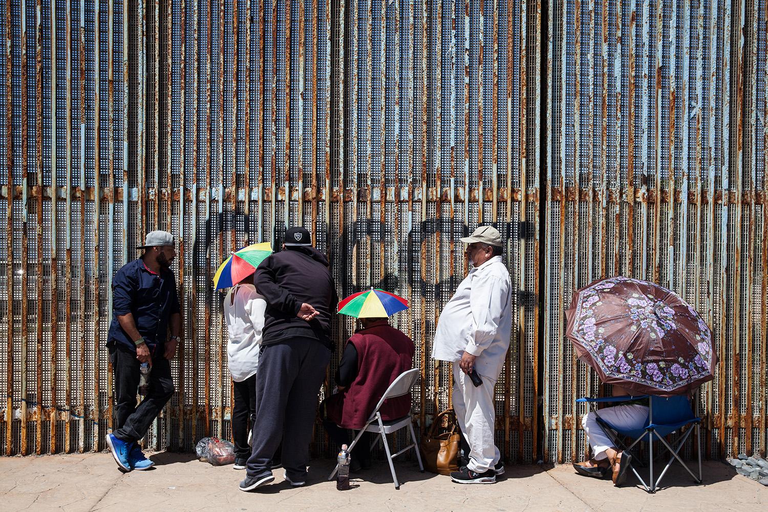 Families at the border fence in Playas de Tijuana, Mexico visit loved ones that are living in the...